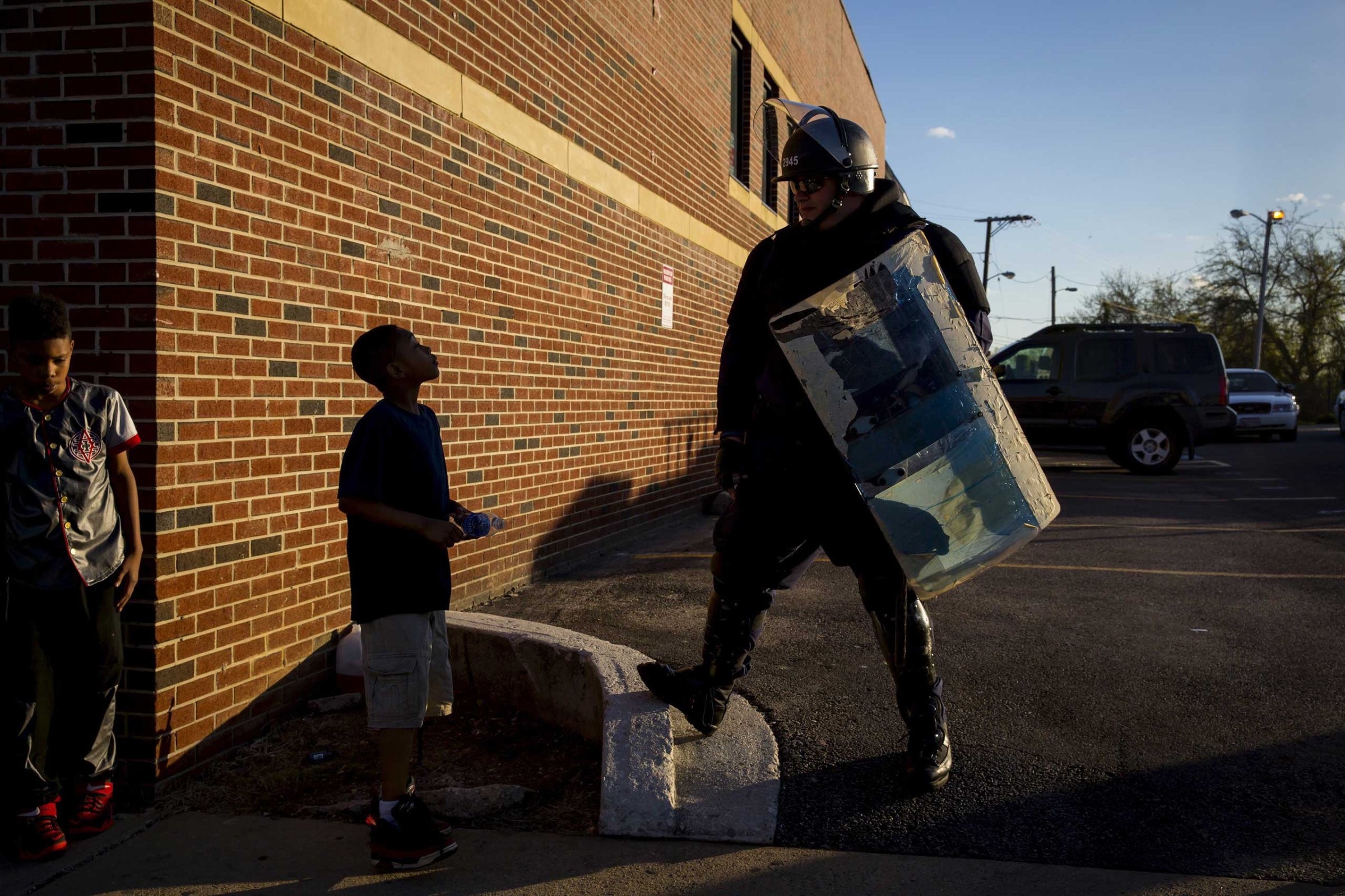 A boy talks to a police officer near North Ave and Pennsylvania Ave in Baltimore on April 28, 2015