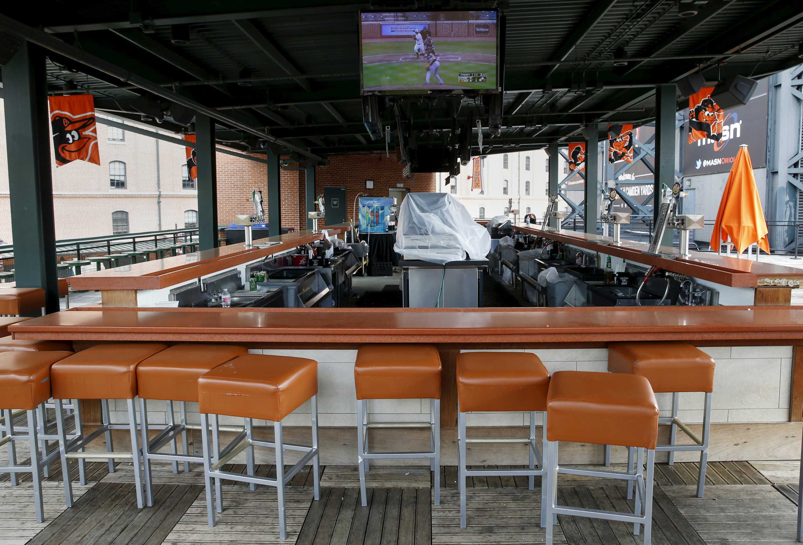 The Baltimore Orioles against Chicago White Sox American League baseball game is seen televised at an empty bar inside Oriole Park at Camden Yards in Baltimore on April 29, 2015.