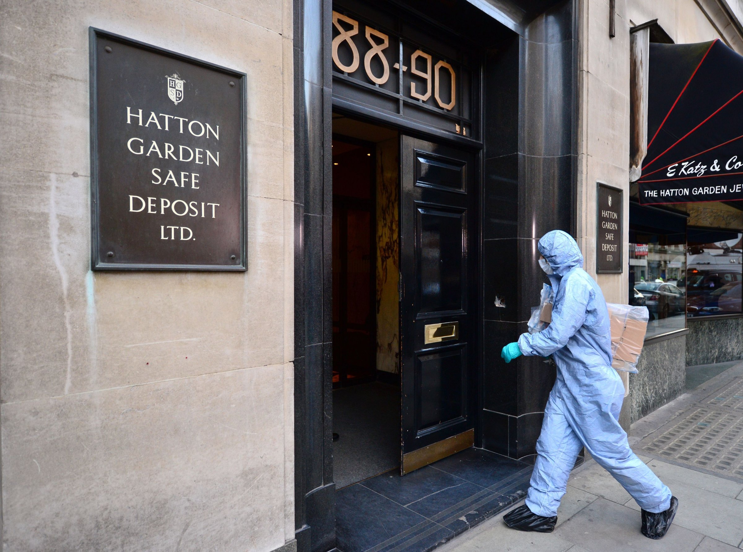 A police forensics officer enters the Hatton Garden Safe Deposit company in London Tuesday May 7, 2015 after it was burgled over the weekend.
