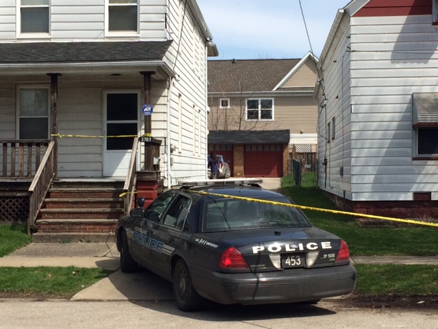 Authorities investigate the scene after a shooting involving two children Sunday, April 12, 2015, in Cleveland.