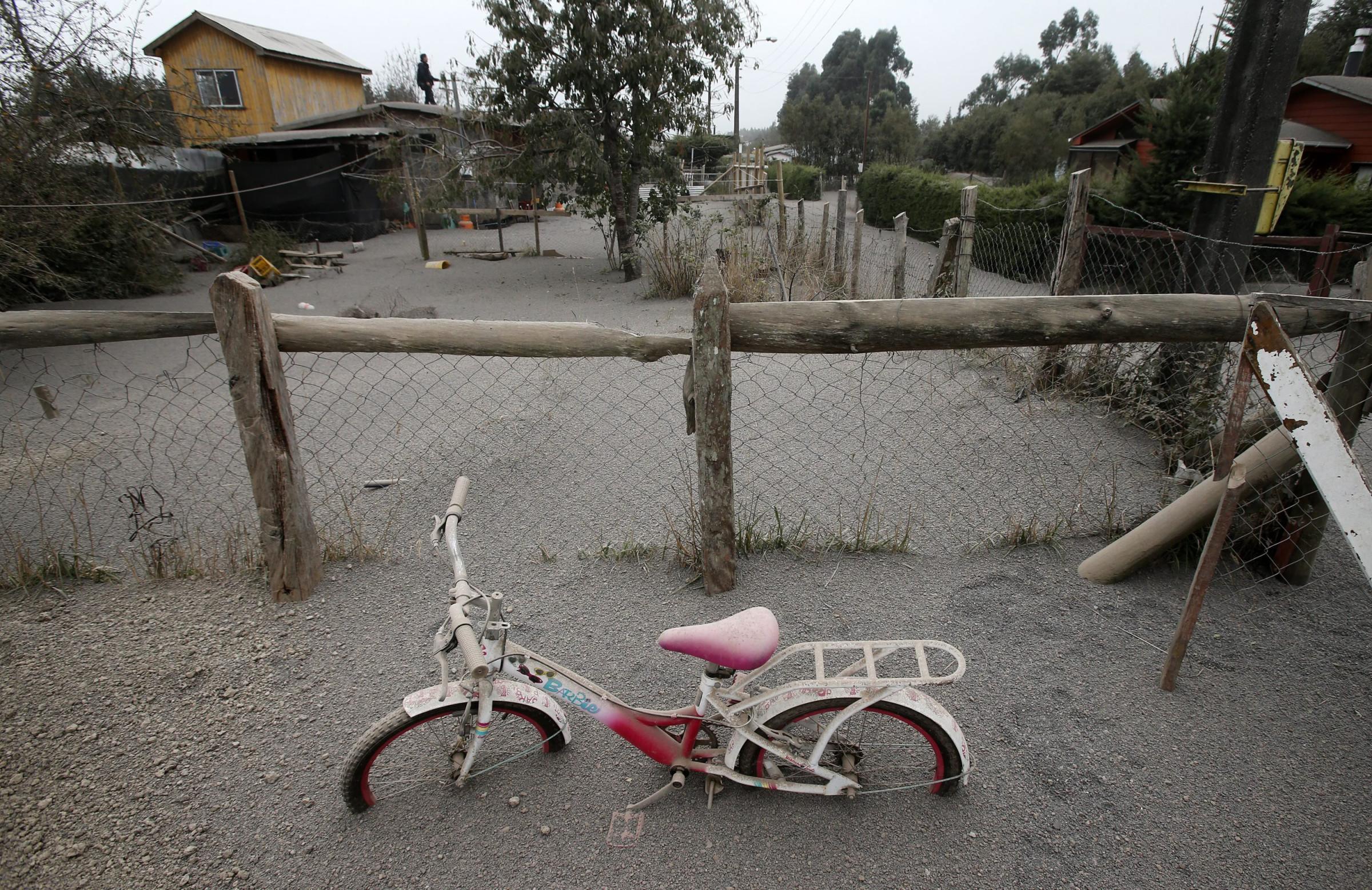 A child's bicycle sits, covered in ash on the outskirts of Calbuco volcano, which after 40 years of inactivity, erupted