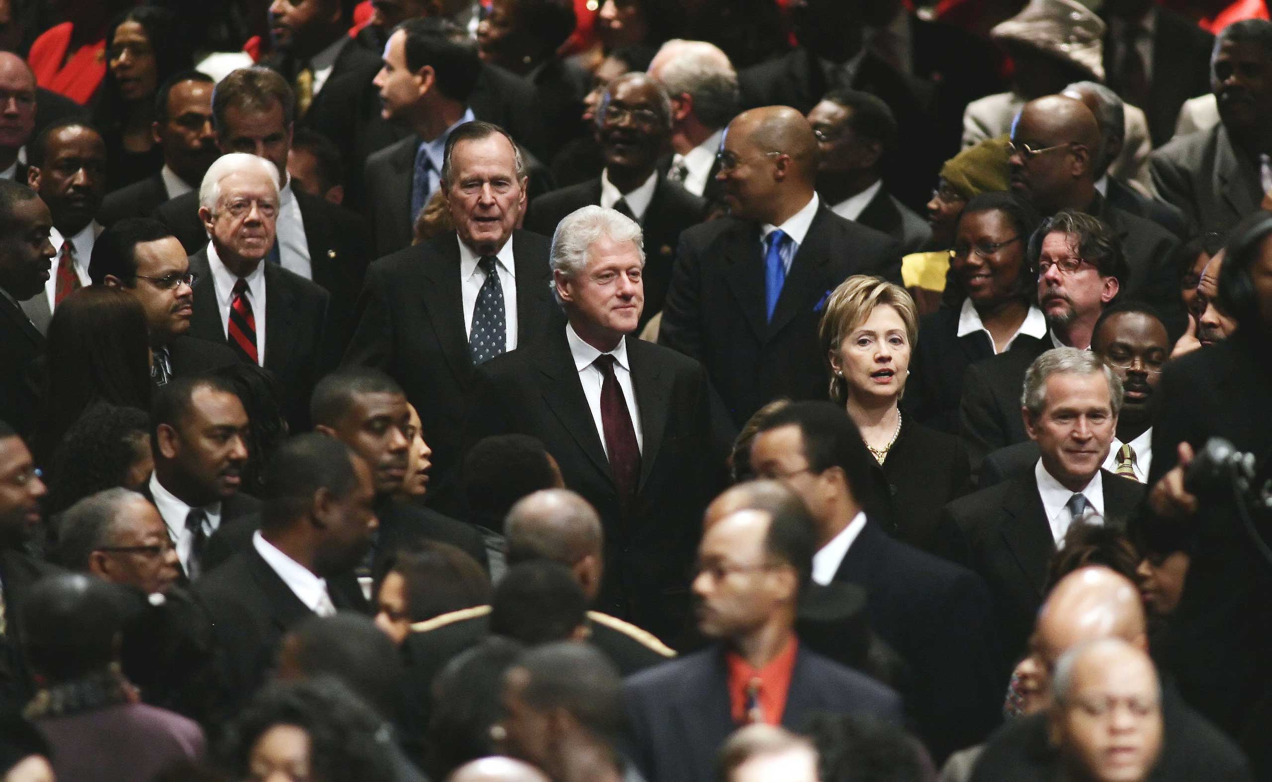 President George Bush, U.S. Sen. Hillary Clinton, former U.S. President Bill Clinton, former U.S. President George H. W. Bush, and former U.S. President Jimmy Carter walk through the crowd during the funeral for Coretta Scott King at the New  Birth Missionary Baptist Church in Lithonia, Ga. on Feb. 7, 2006. (Jason Reed—Pool/Getty Images)