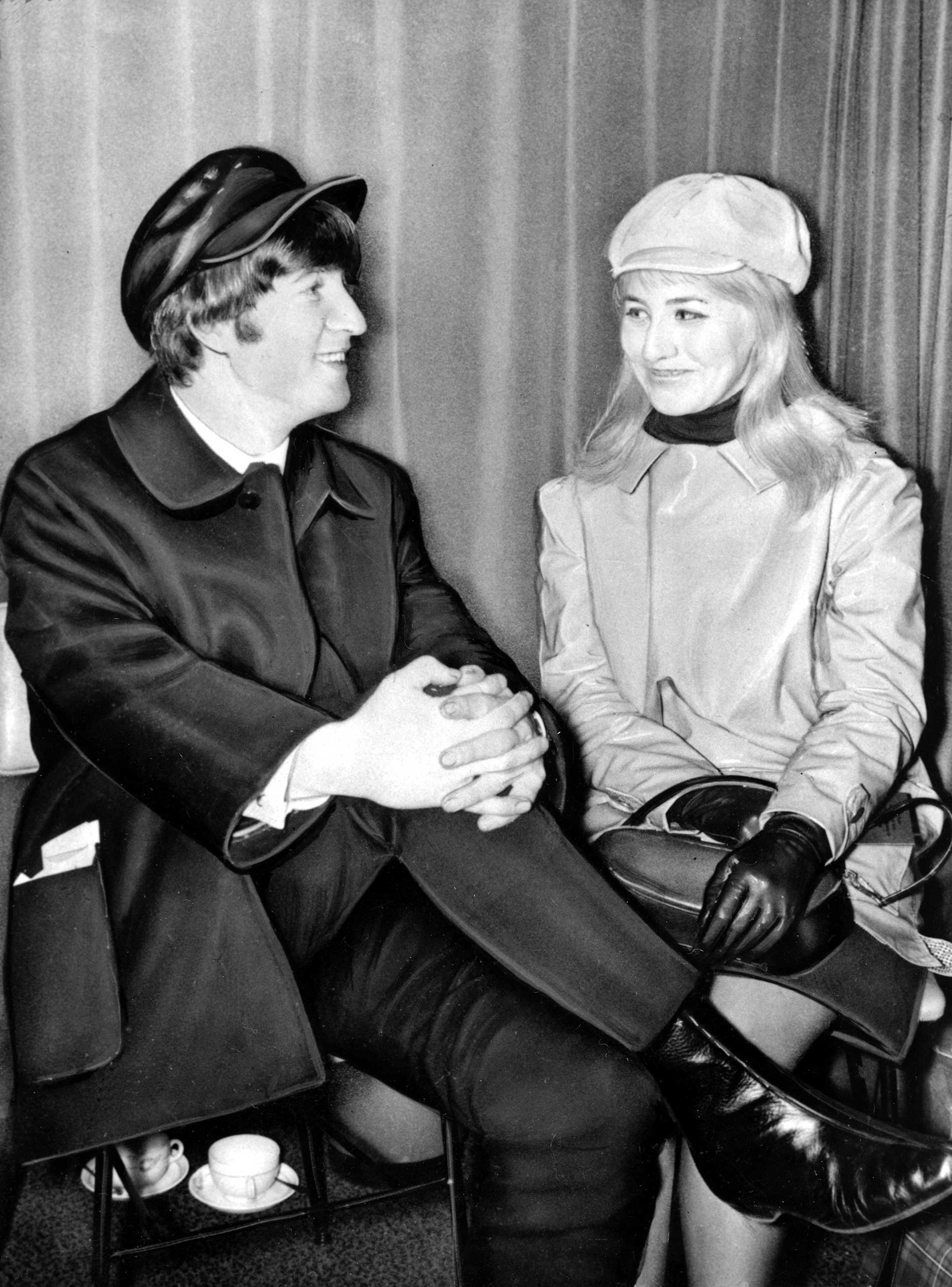 Beatle John Lennon and his wife, Cynthia, sit in London Airport, England, before flying to the U.S. on Feb. 7, 1964.