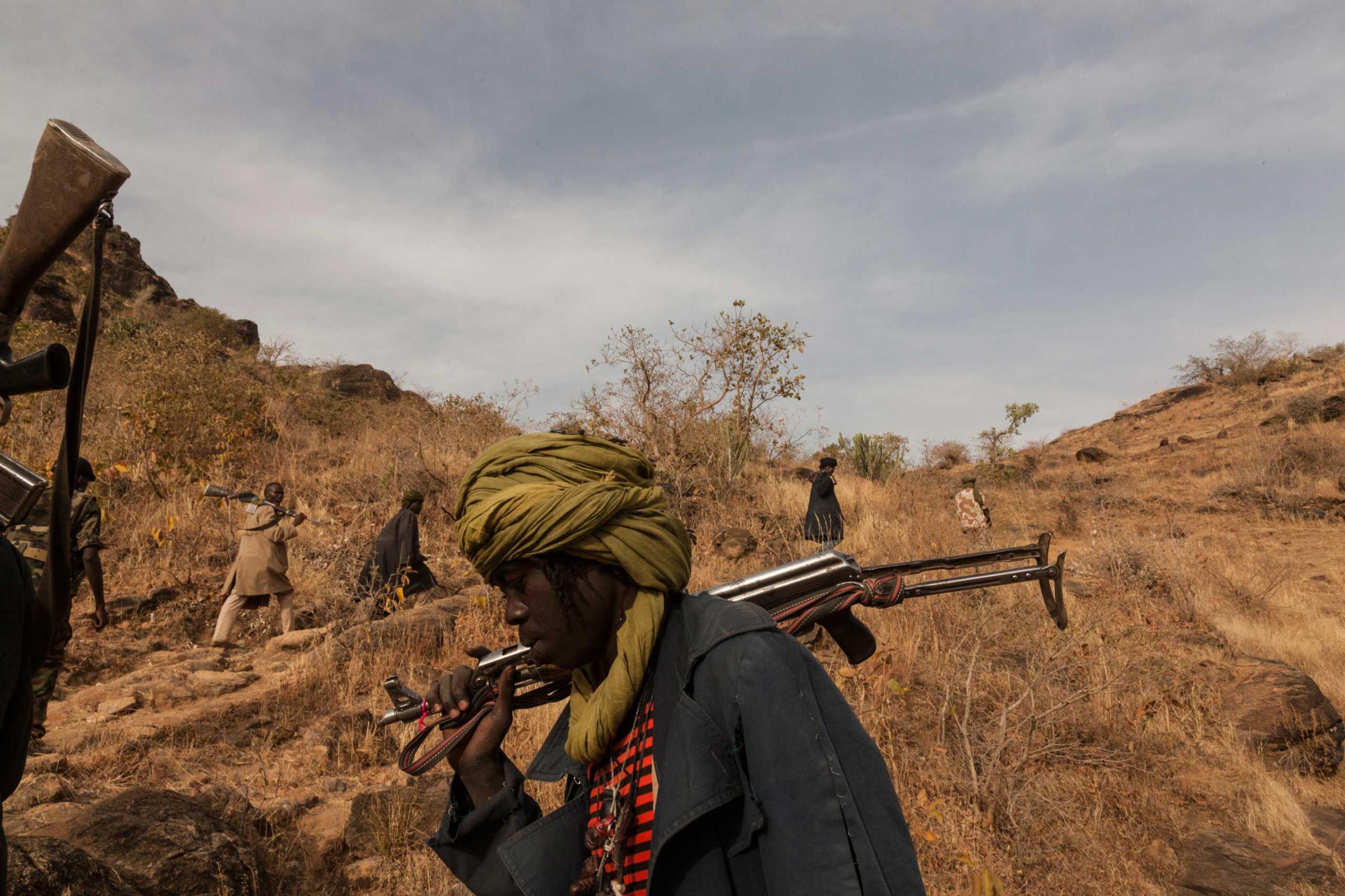 Members of the rebel group Sudan Liberation Army led by Abdul Wahid (SLA-AW) climb towards the front lines in Jebel Marra, Central Darfur, Sudan, on March 4, 2015. The mountainous area has been a stronghold of the SLA-AW since the conflict between the neglected population and the Sudanese government broke out in 2003.