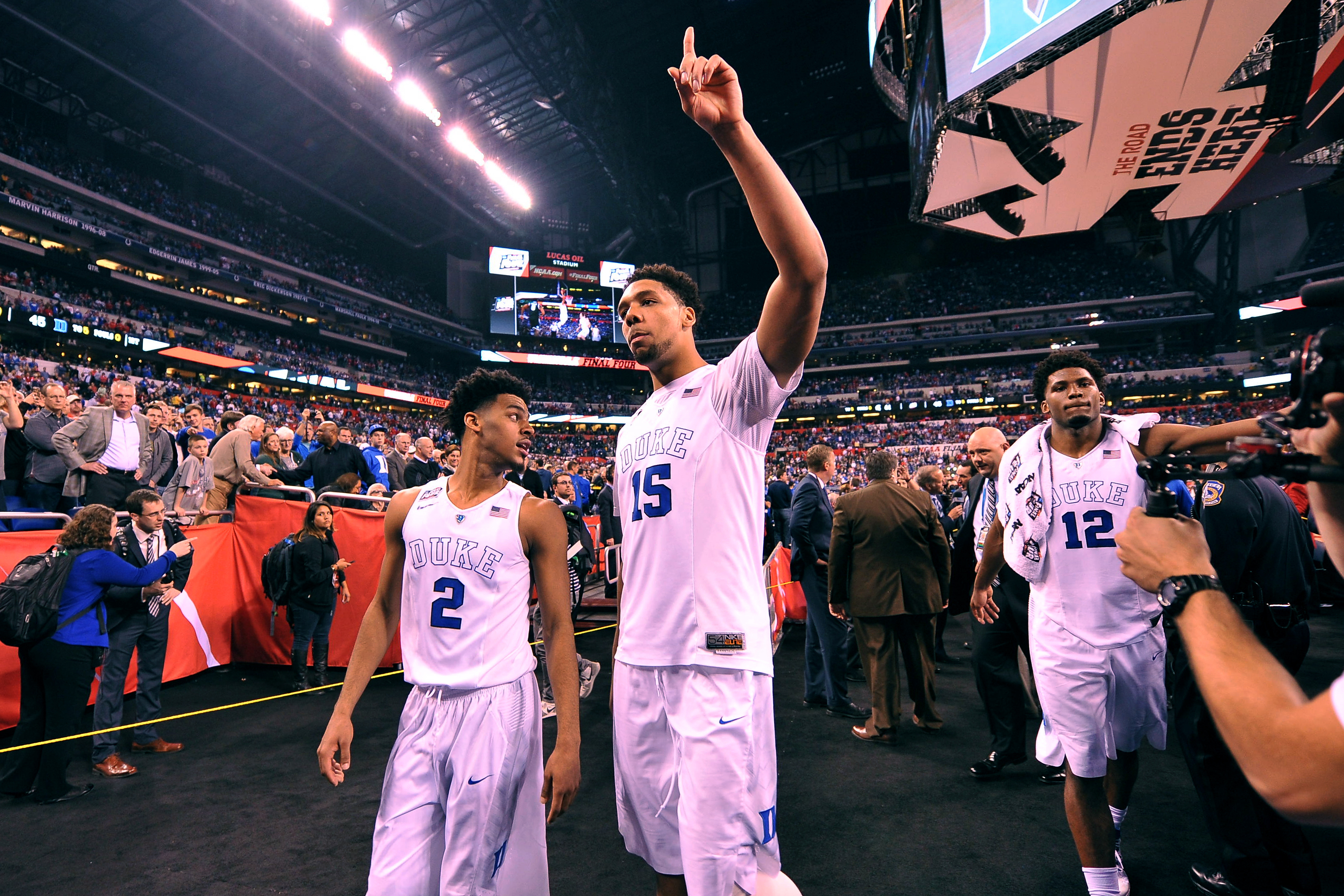 Quinn Cook #2, Jahlil Okafor #15 and Justise Winslow #12 of the Duke Blue Devils acknowledge fans while walking off the court following their 81-61 win against the Michigan State Spartans during the NCAA Men's Final Four Semifinal at Lucas Oil Stadium on April 4, 2015 in Indianapolis, Indiana.
