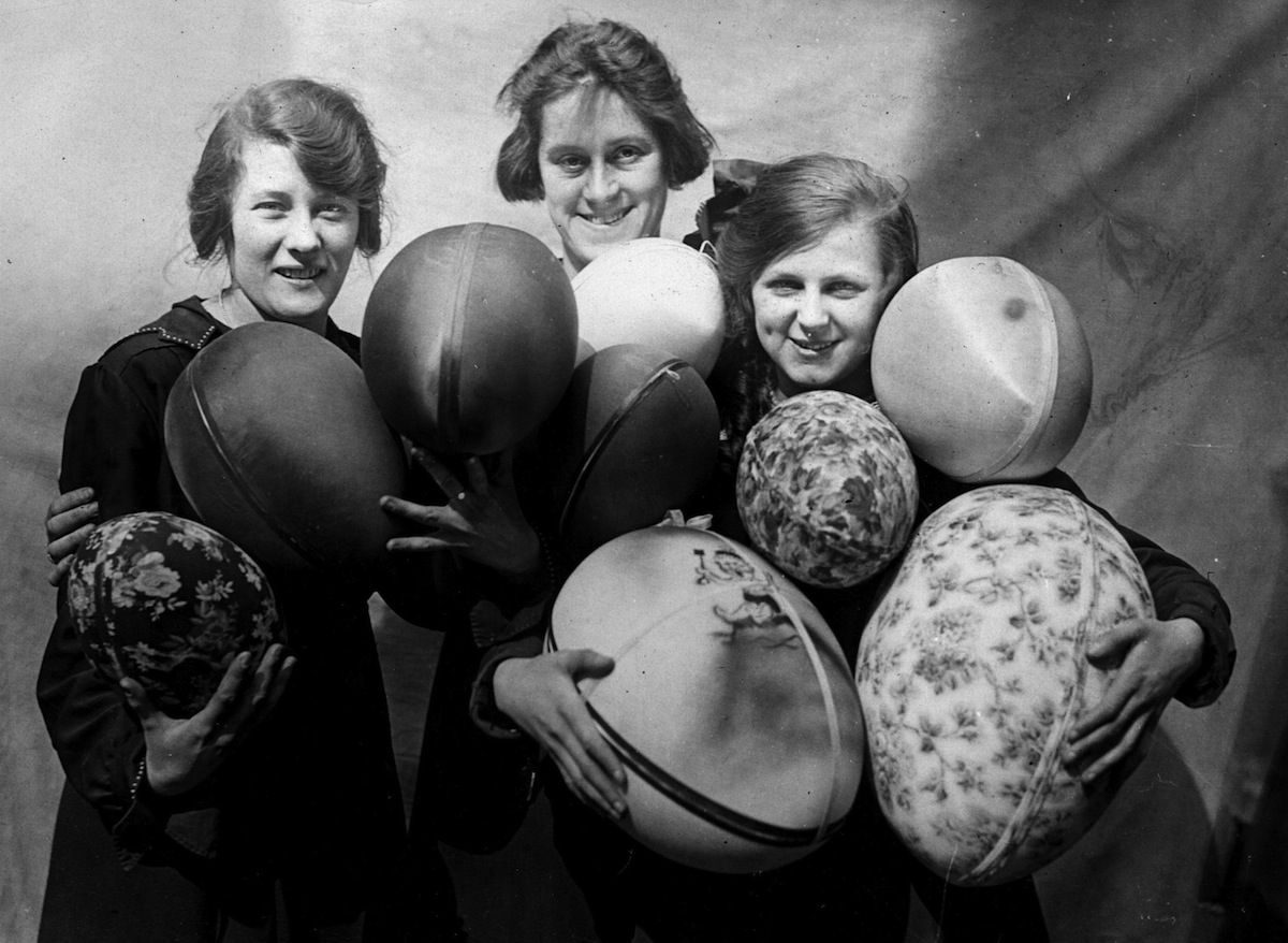 Three women holding armfuls of large Easter eggs, circa 1925 (Hulton Archive/Getty Images)