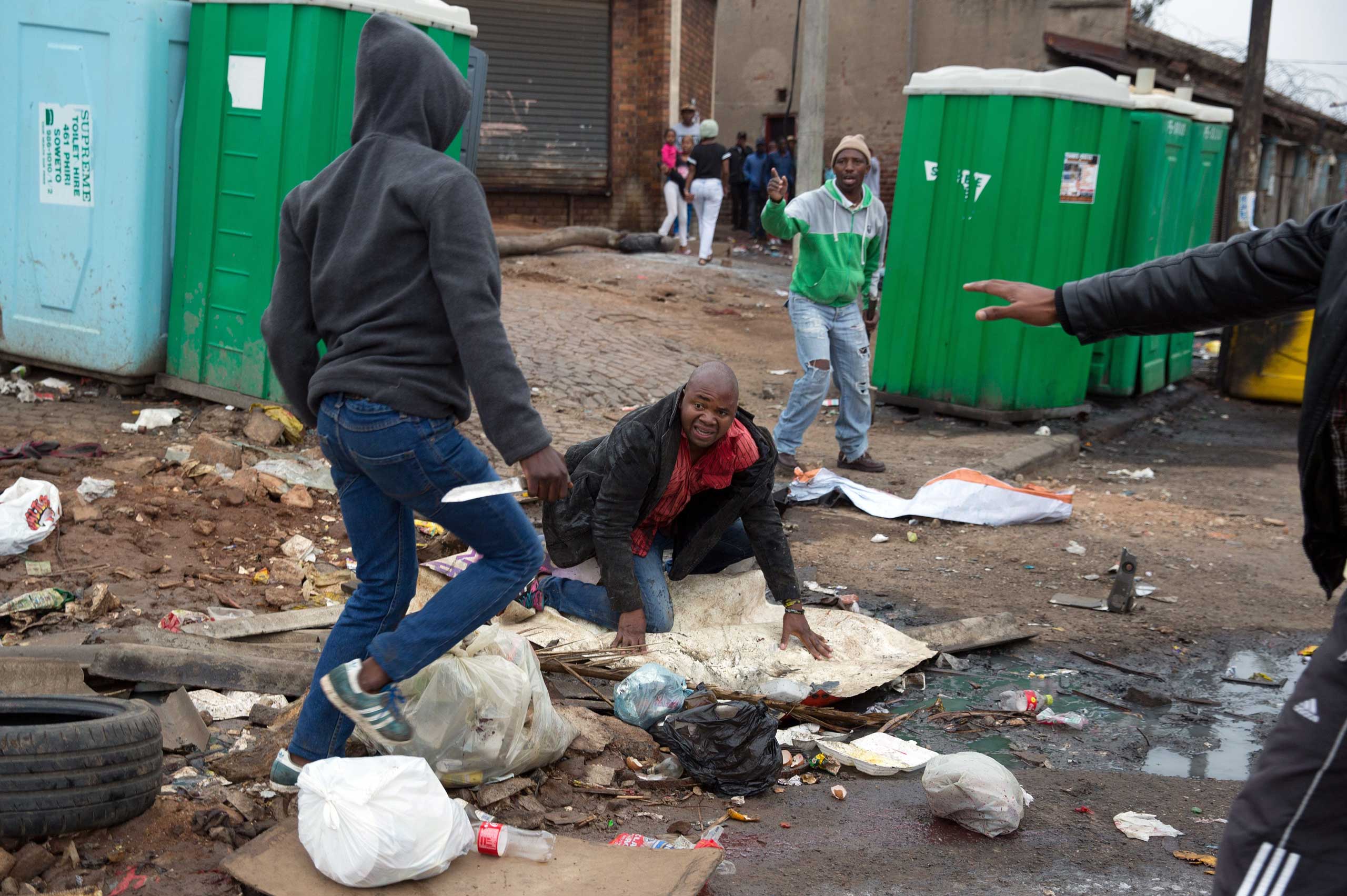 Sithole is attacked by men in Alexandra township during anti-immigrant violence in Johannesburg on April 18, 2015.