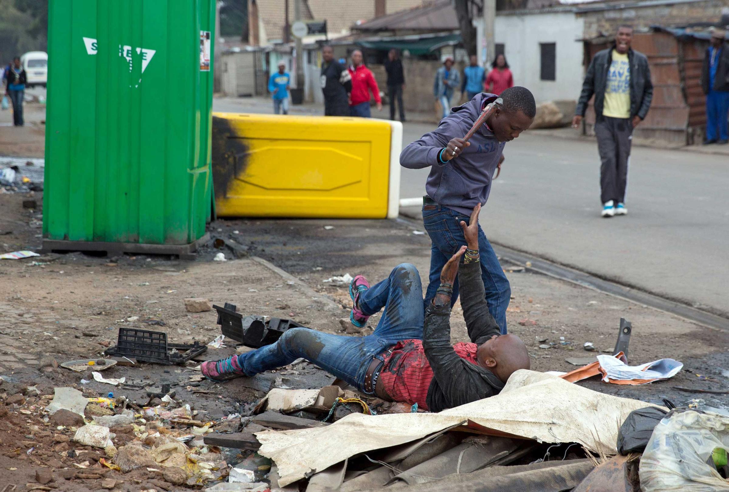 Mozambique national Emmanuel Sithole is attacked in Alexandra township during anti-immigrant violence  in Johannesburg