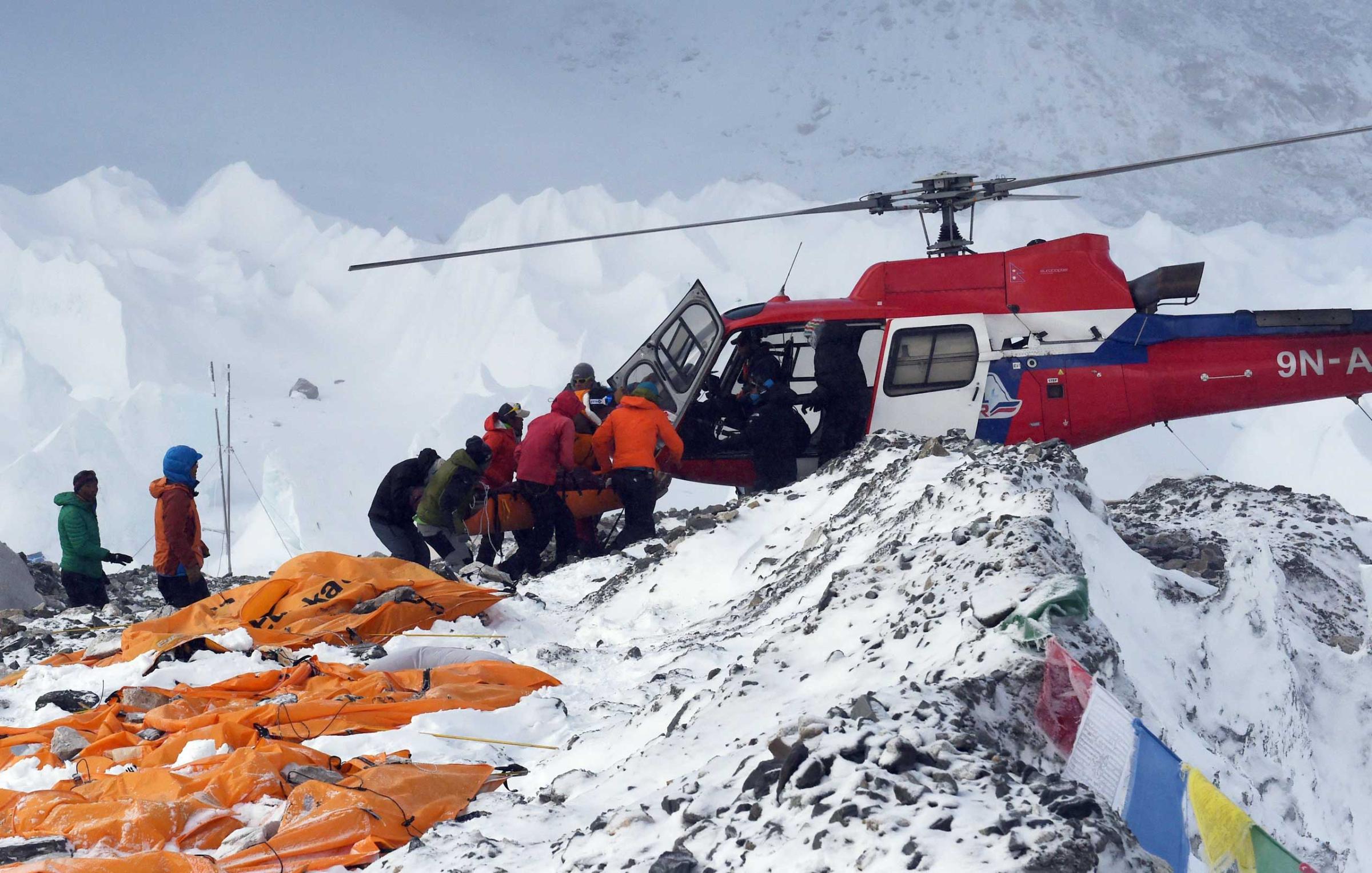 An injured person is loaded onto a rescue helicopter at Everest Base Camp on April 26, 2015.
