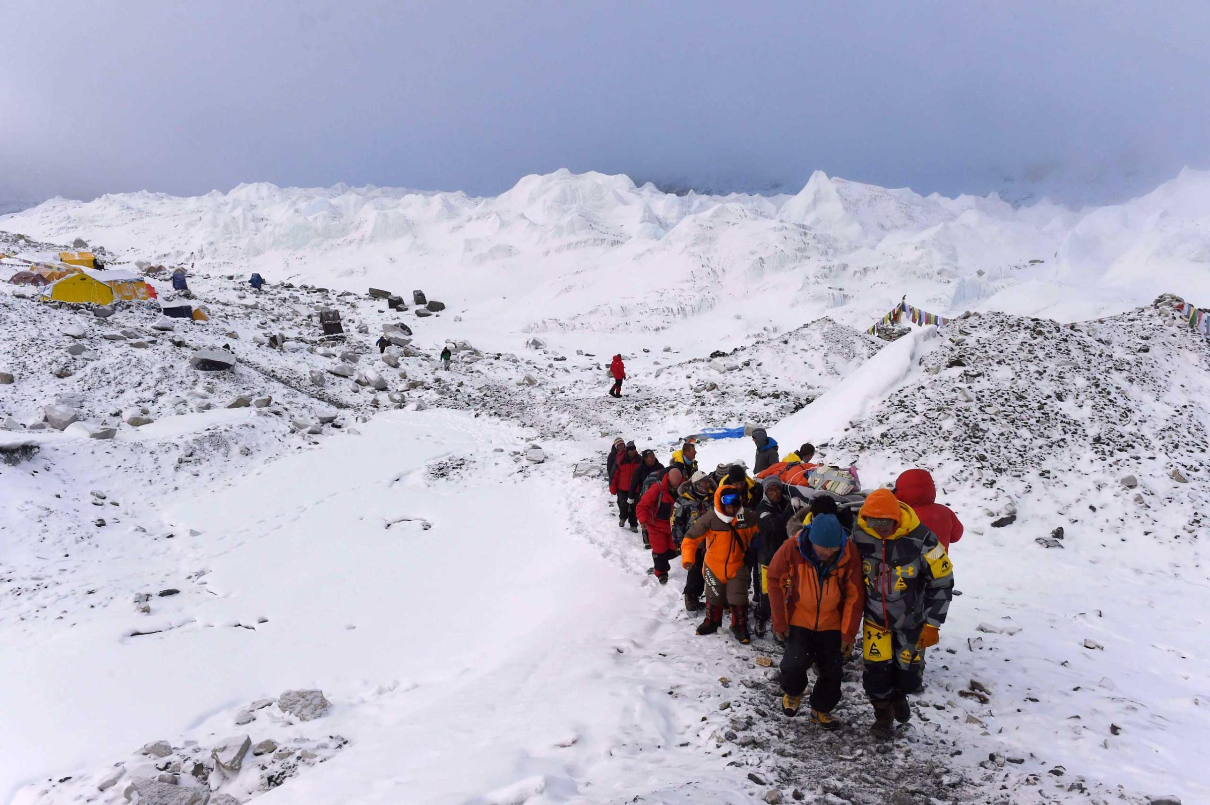 A person injured in Saturday's avalanche is carried by rescue members to be airlifted by a rescue helicopter at Everest Base Camp on April 26, 2015.