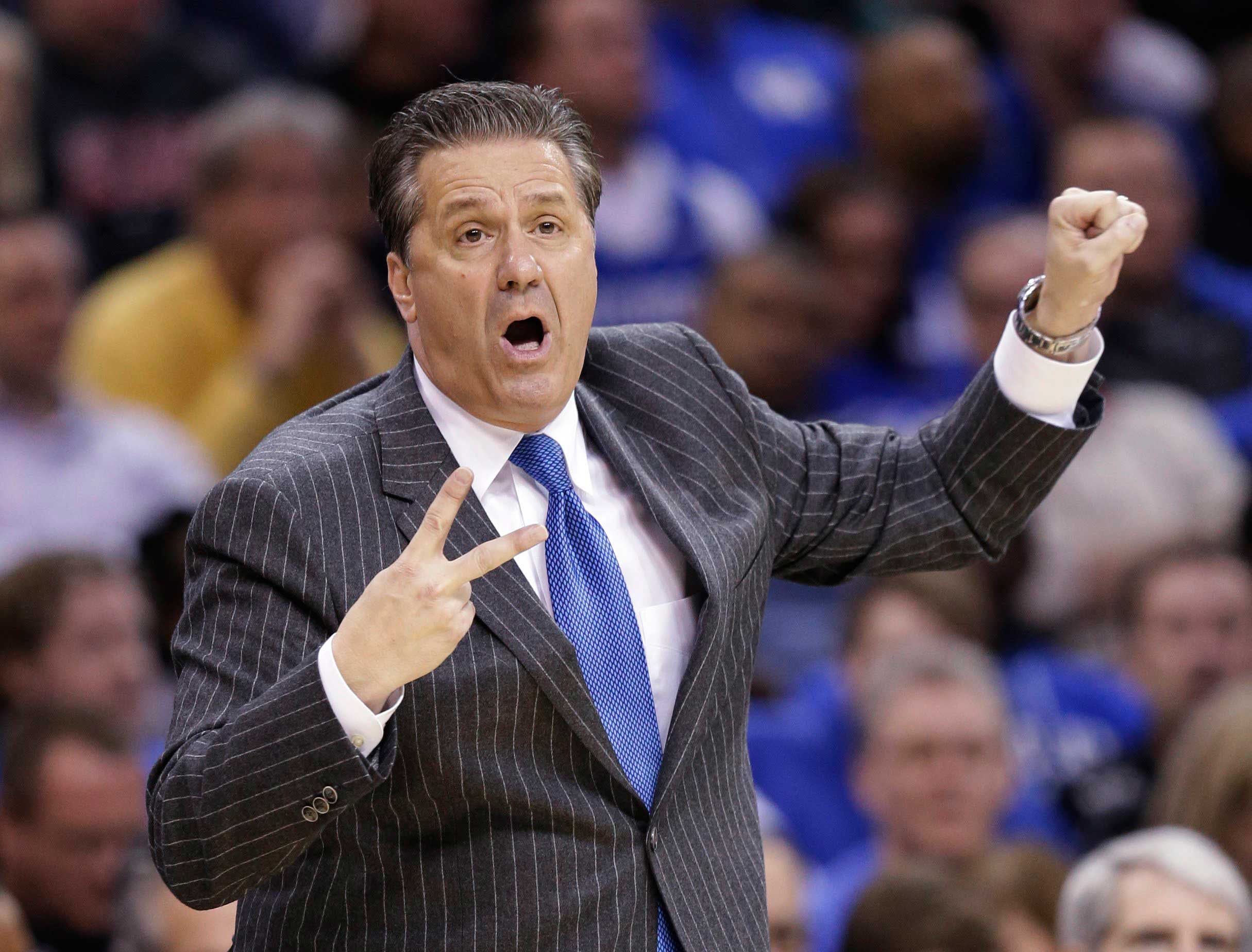 Kentucky coach John Calipari signals to his team during the first half of a college basketball game against Notre Dame in the NCAA men's tournament regional finals in Cleveland, March 28, 2015.