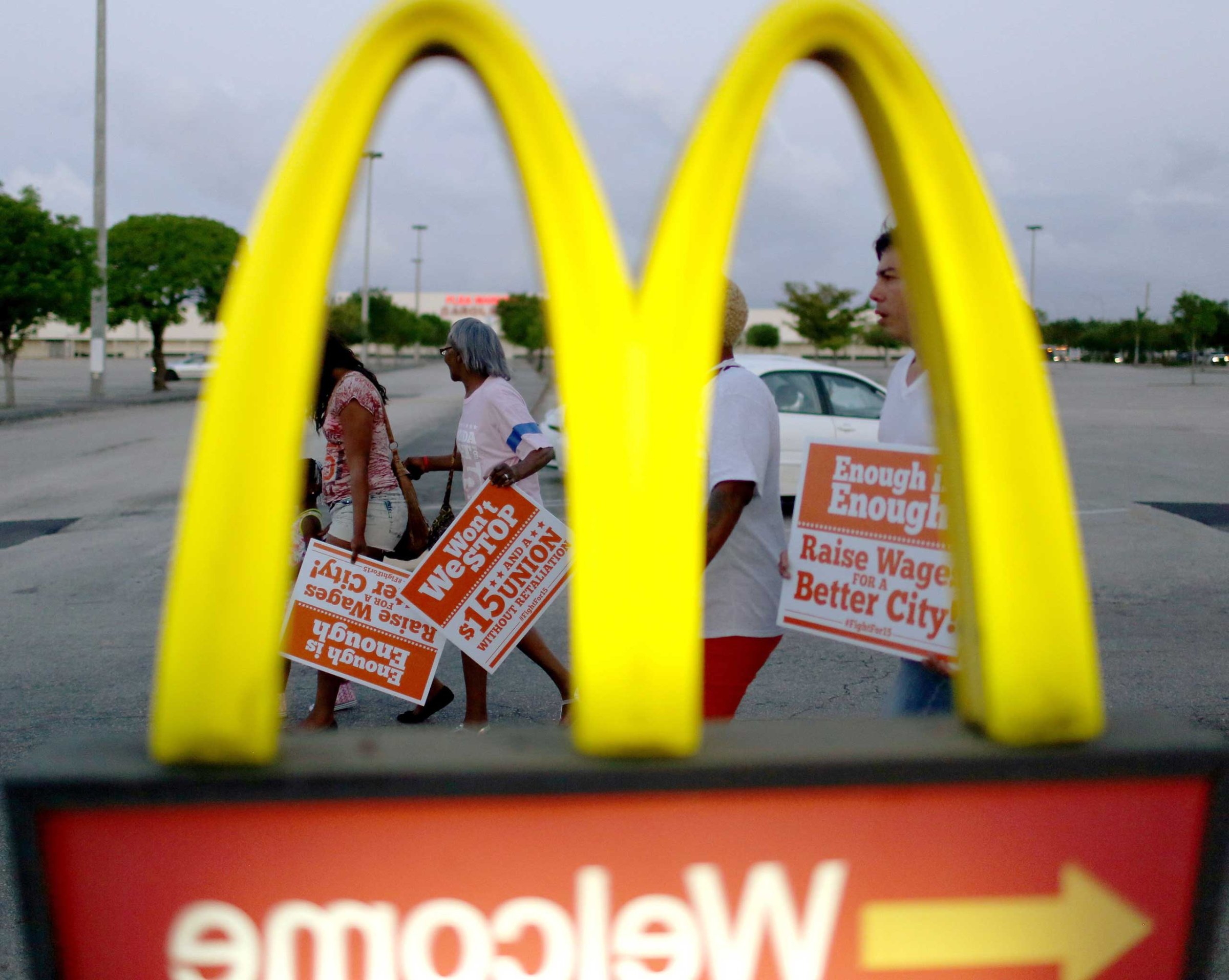 Protesters gather at a McDonald's restaurant on tax day asking for higher wages in Miami Gardens, Fla., on April 15, 2015.