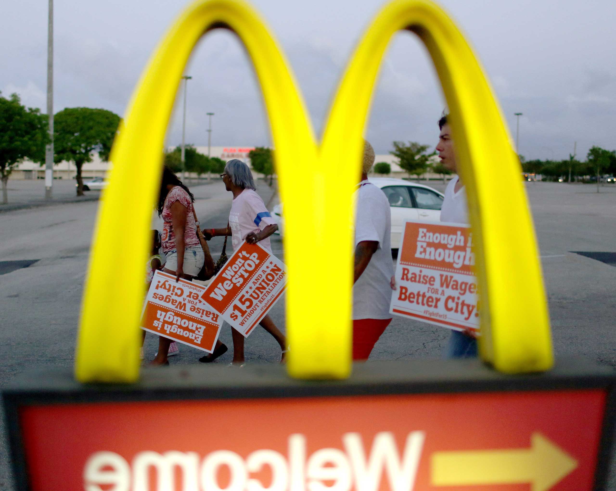 Protesters gather at a McDonald's restaurant on tax day asking for higher wages in Miami Gardens, Fla., on April 15, 2015. (Joe Raedle—Getty Images)
