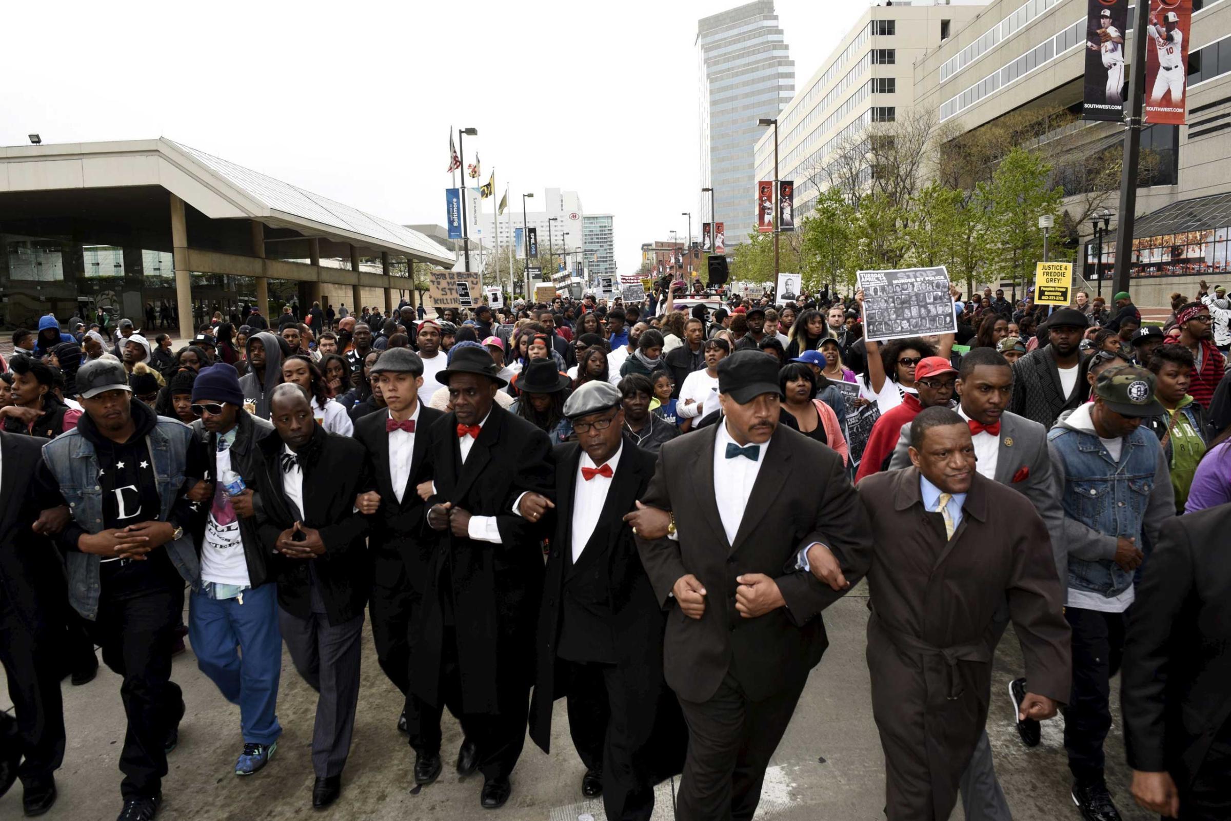 Demonstrators march to City Hall to protest against the death of Freddie Gray in police custody, in Baltimore on April 25, 2015.