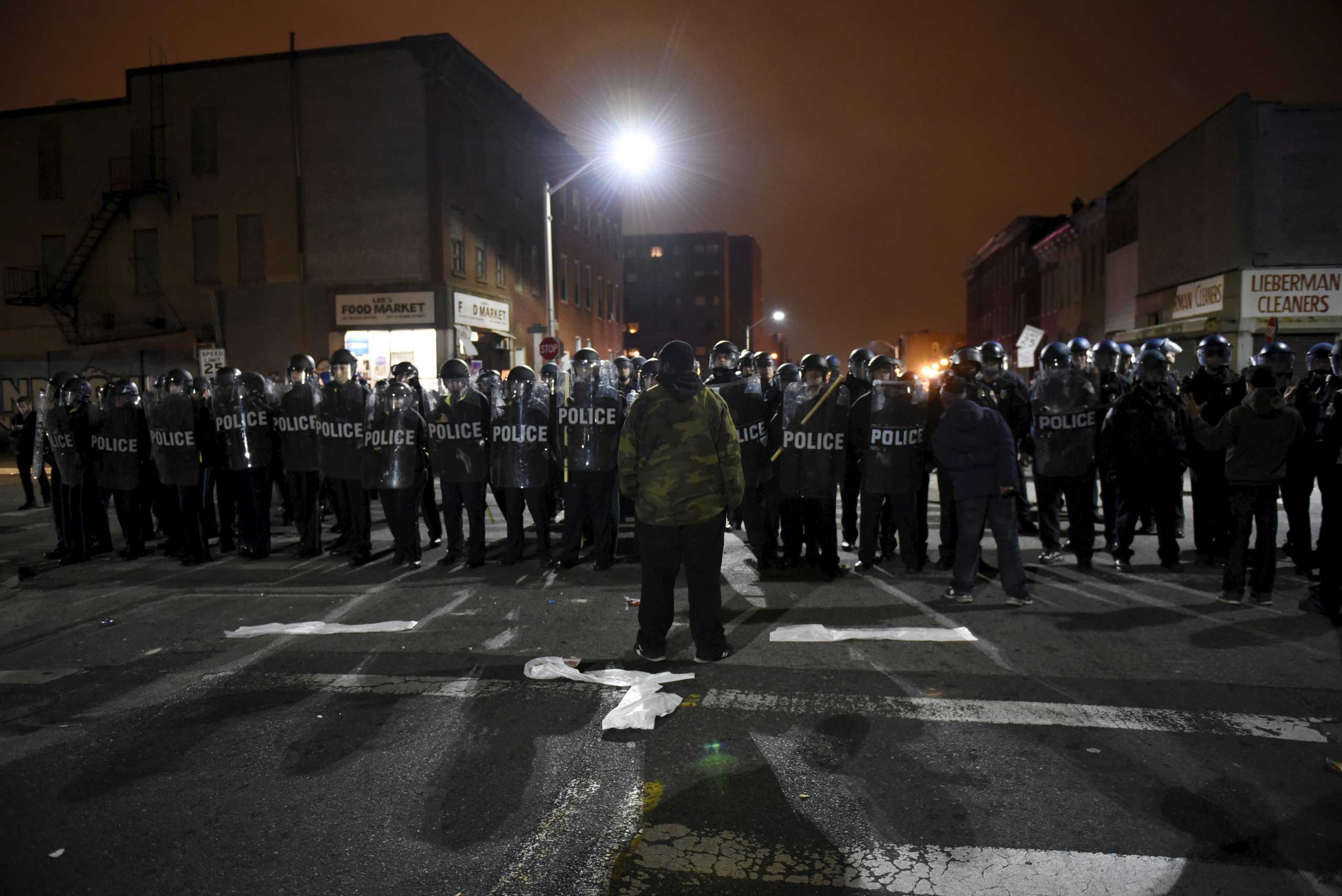 A demonstrator confronts law enforcement officers near Baltimore Police Department Western District in Baltimore on April 25, 2015. (Sait Serkan Gurbuz—Reuters)