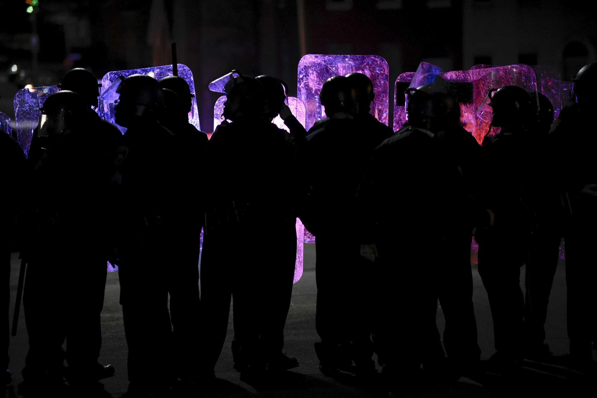 Law enforcement officers stand guard near Baltimore Police Department Western District in Baltimore on April 25, 2015.