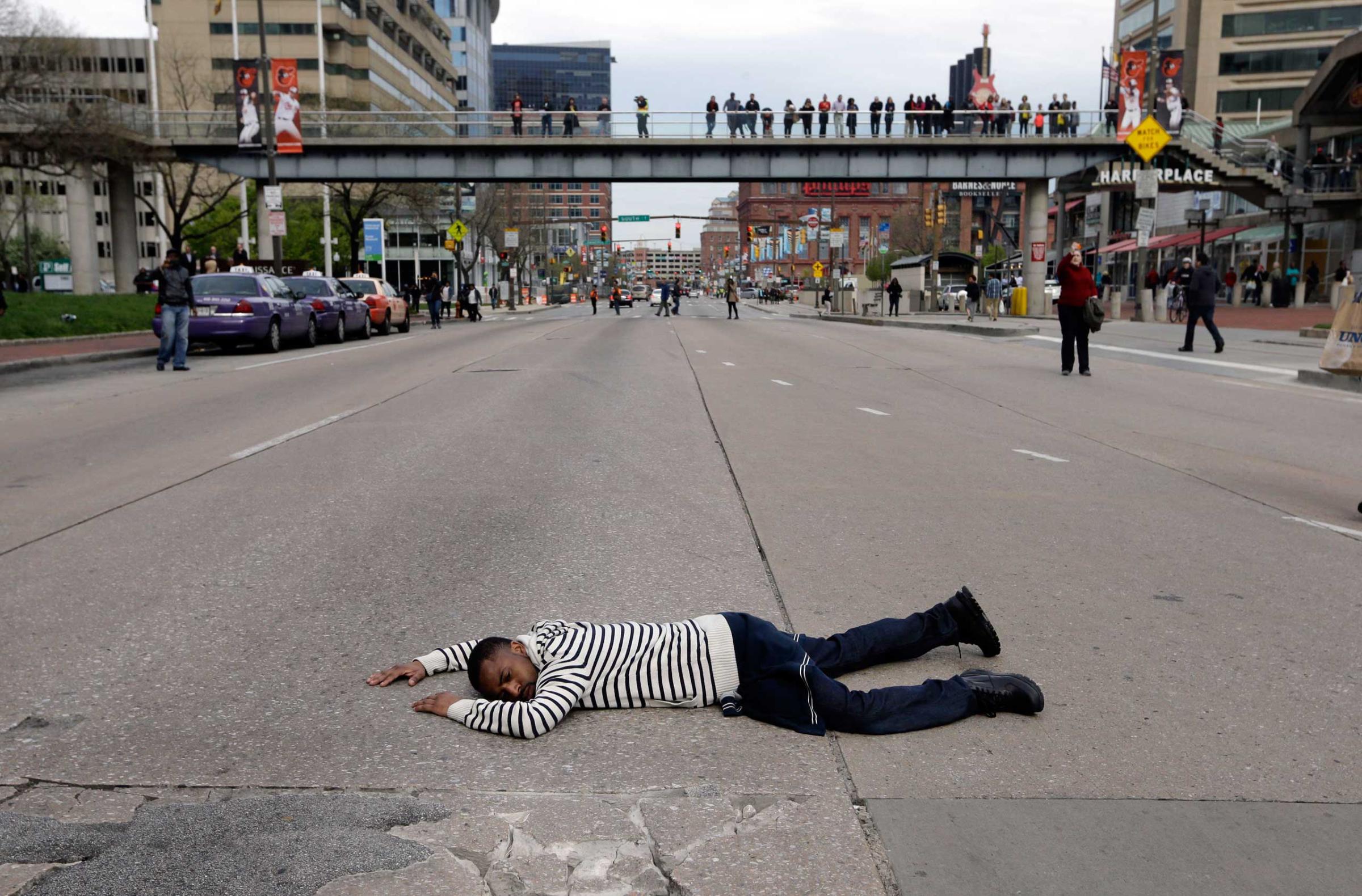 A protestor lays in the middle of a street during a march for Freddie Gray in Baltimore on April 25, 2015.