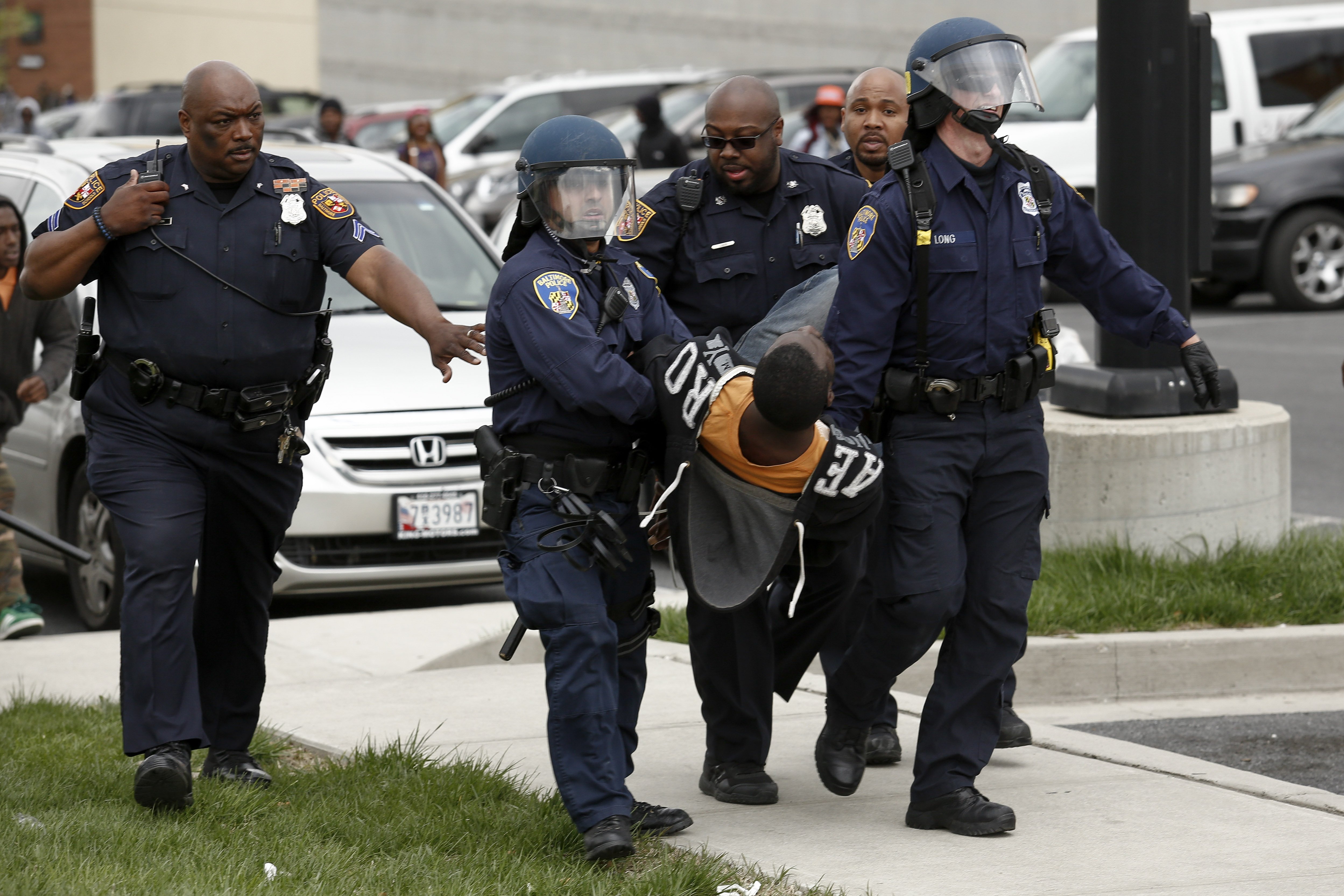Police officers arrest a man near Mondawmin Mall in Baltimore on April 27, 2015.