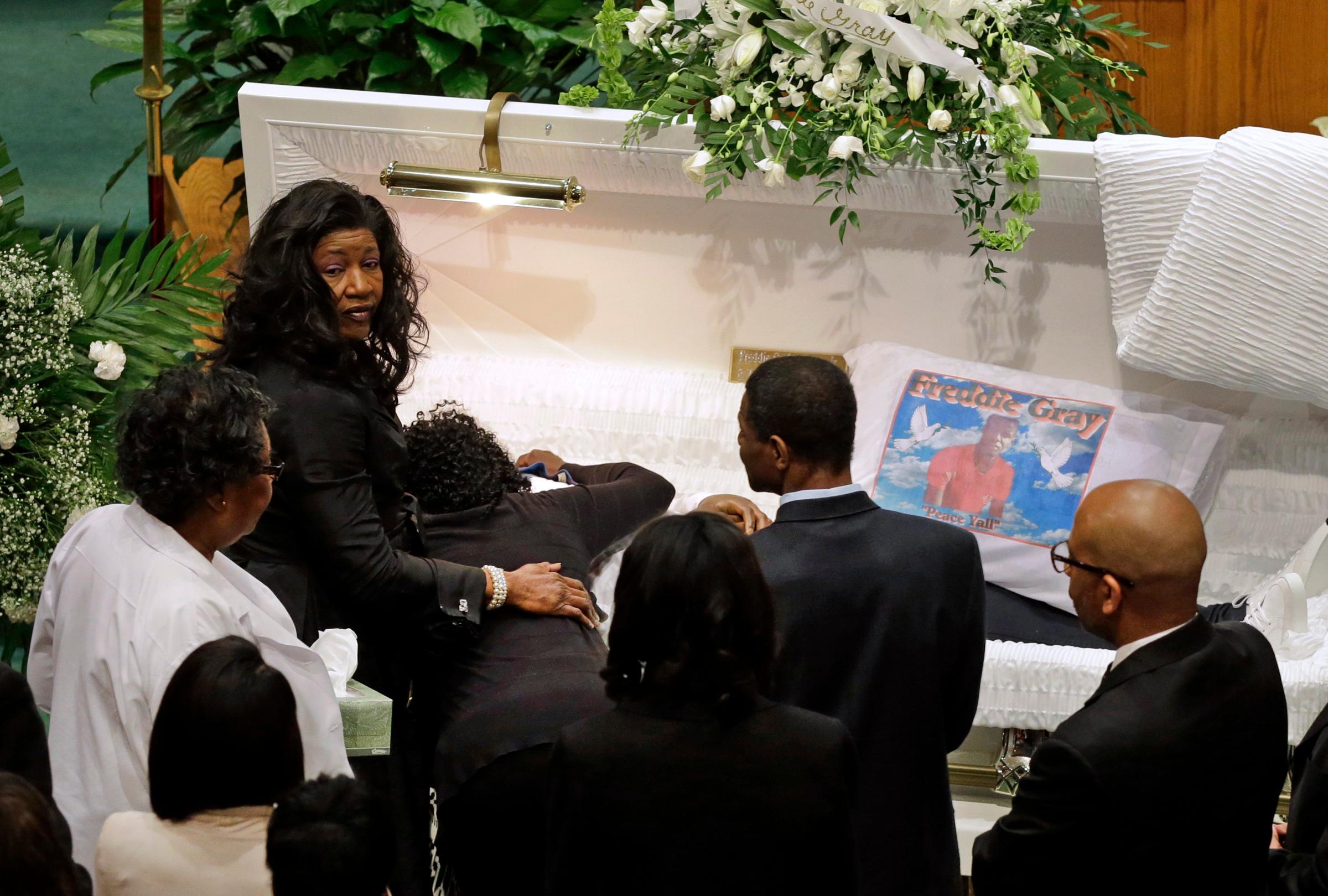 Gloria Darden, mother of Freddie Gray, is comforted as she embraces his body before his funeral at New Shiloh Baptist Church in Baltimore on April 27, 2015.
