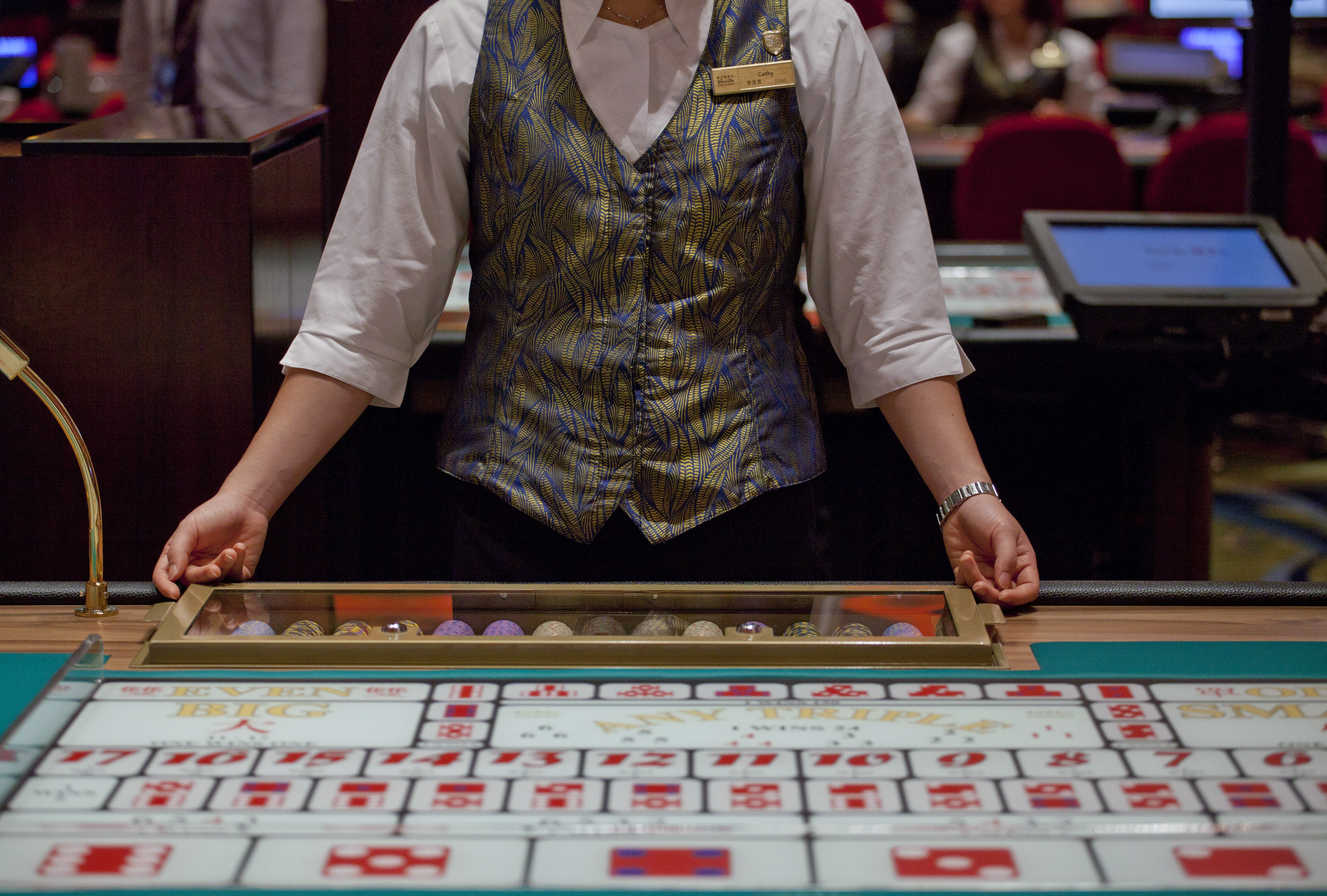 A croupier sits in front of a gaming table inside a casino on the opening day of Sheraton Macao hotel at Sands Cotai Central in Macau September 20, 2012 (Siu Chiu—Reuters)