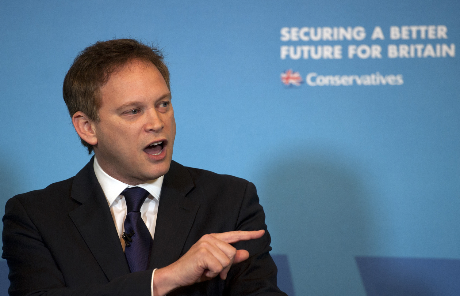 Conservative Party chairman Grant Shapps gives a speech on free trade at the Institute of Directors in London on Feb. 12, 2015 (Hannah McKay — AP)