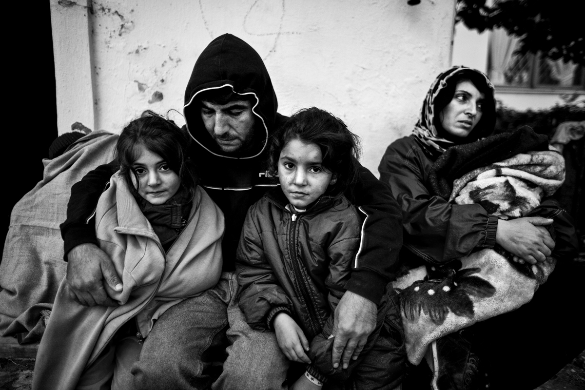 A Palestinian family is seen resting at a train station after a five hour journey on foot from the Greek-Turkish border.