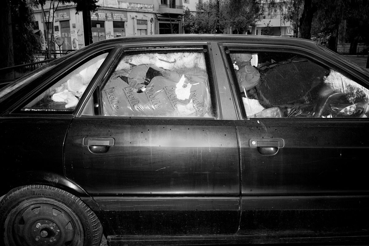 Clothes are packed in a car which serves as shelter for a homeless man.