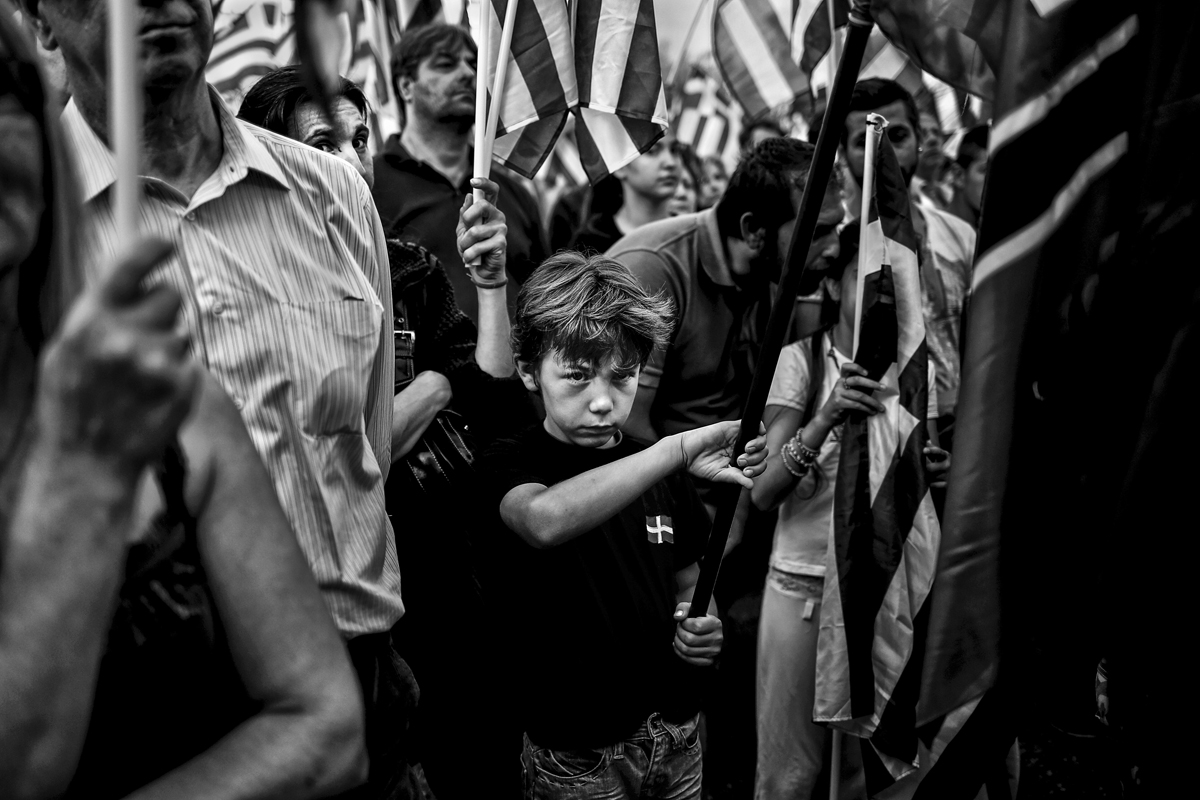 A boy is seen in a crowd at a Golden Dawn party pre-election rally in Athens.