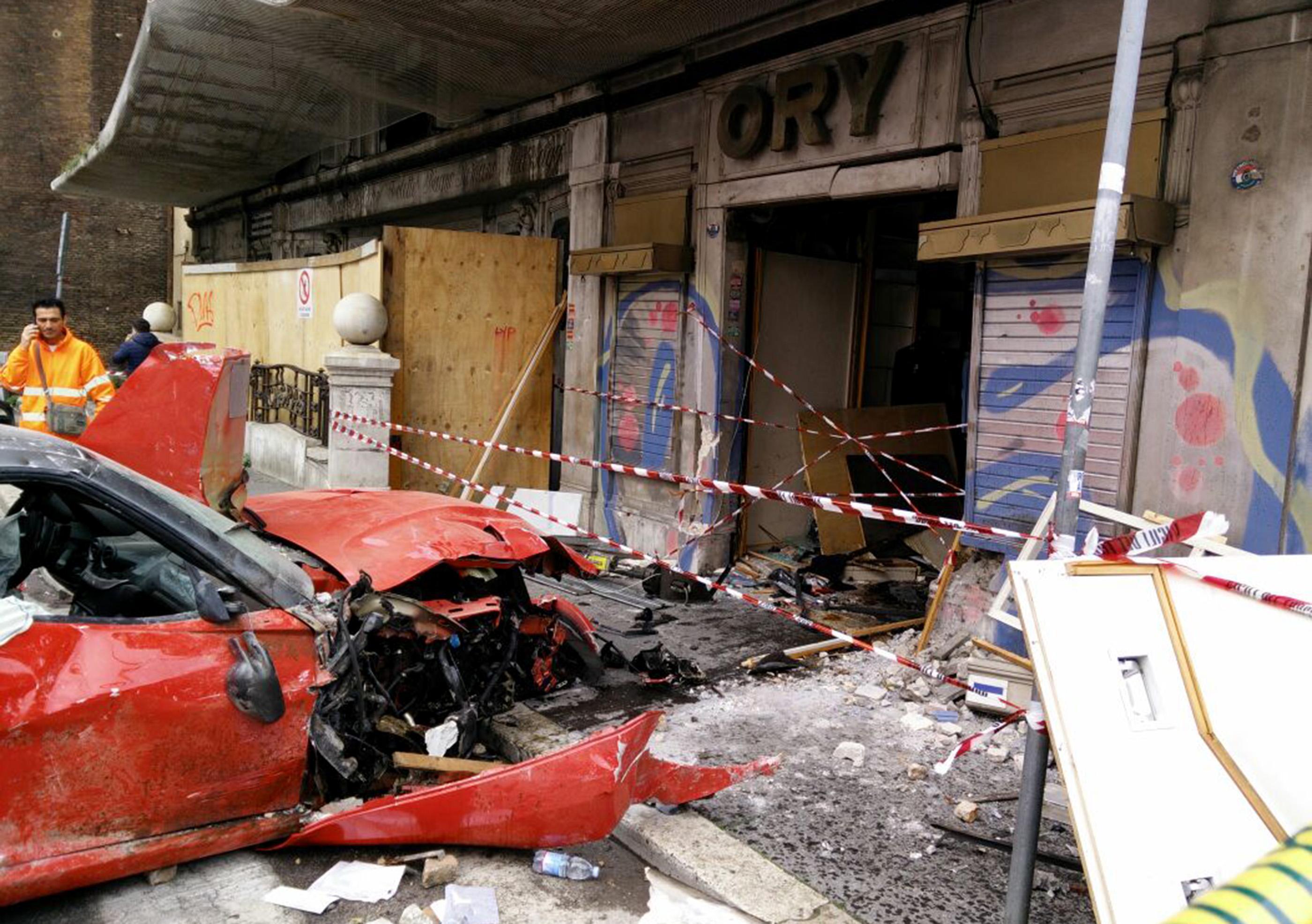 The aftermath following a ferrari 599 GTO which crashed into a shop in Viminale's road in Rome, Italy, on March 30, 2015 (Claudio Peri—EPA)