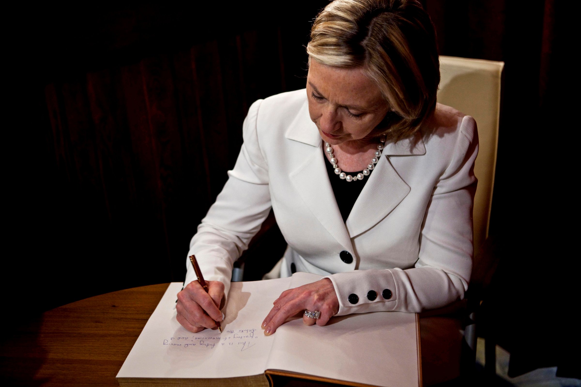 Secretary of State Hillary Rodham Clinton signs the guest book at the Schindler Factory Museum in Krakow, Poland on July 3, 2010.