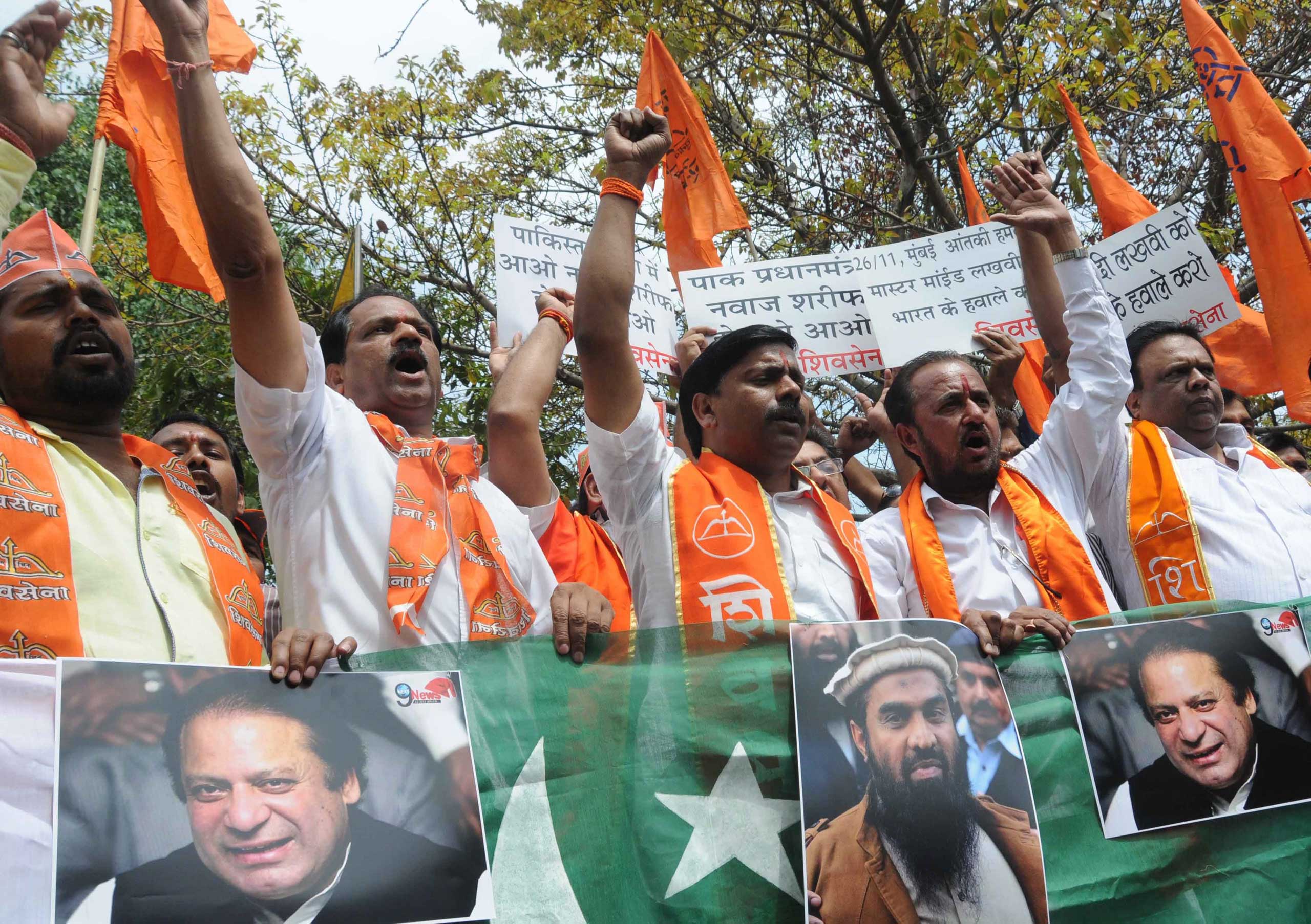 Activists of India's right-wing Shiv Sena party shout slogans before they burnt posters of Pakistani Prime Minister Nawaz Sharif and Zaki-ur-Rehman Lakhvi (C-bottom), alleged mastermind of the 2008 Mumbai attacks during a protest against Zaki-ur-Rehman's release, in New Delhi, on April 11, 2015. (EPA)