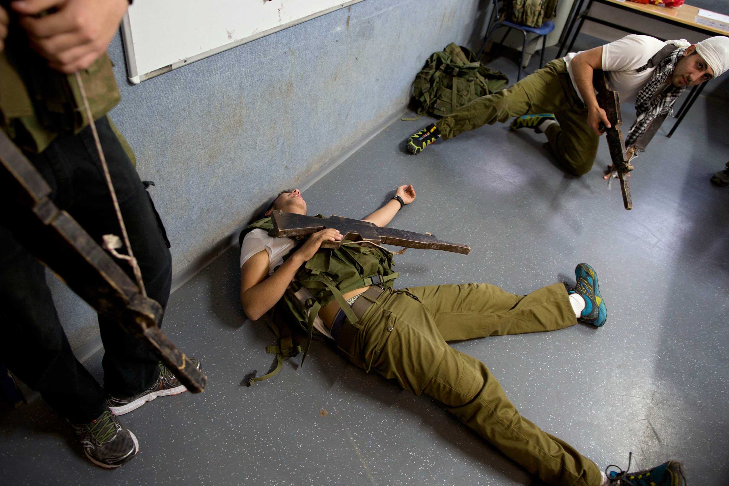 High-school seniors preparing to join the Israeli military participate in an urban fighting drill in Kibbutz Mizra, northern Israel, March 24, 2015.