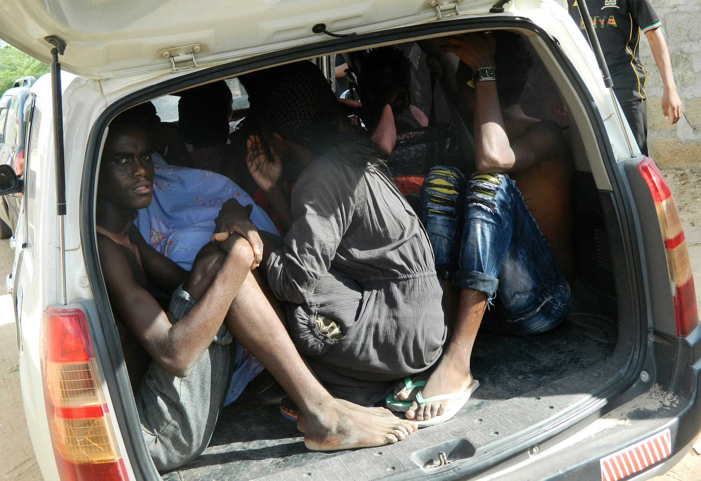 Students of the Garissa University College take shelter in a vehicle after fleeing from an attack by gunmen in Garissa, Kenya, April 2, 2015.
