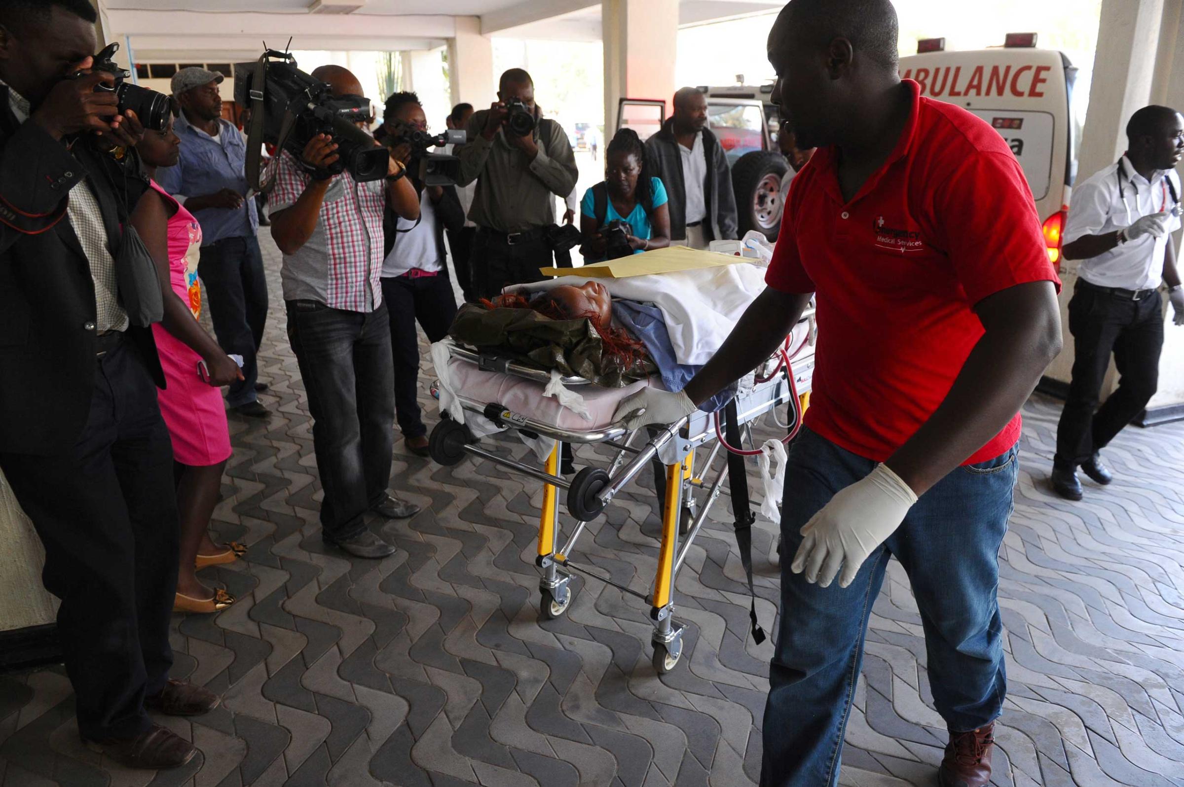 Medics help an injured person at Kenyatta National Hospital in Nairobi after being airlifted from the site of an attack at Garissa University College, in northeastern Kenya, on April 2, 2015.