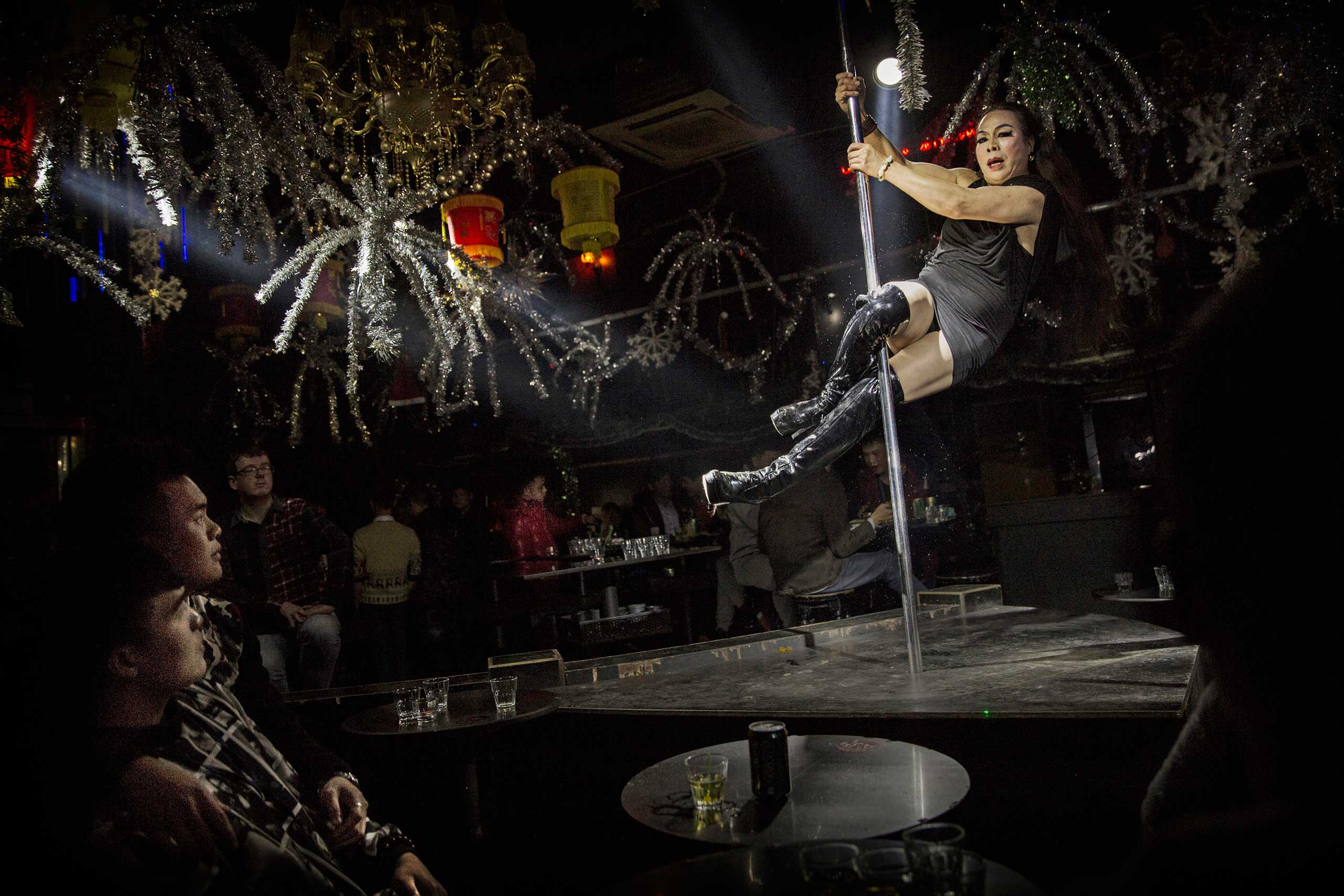 Chinese drag queen who goes by the name Shancun swings on a pole while performing a routine for customers at the Chunai 98 club in Nanning, Guangxi Province, southern China, Jan. 10, 2015.