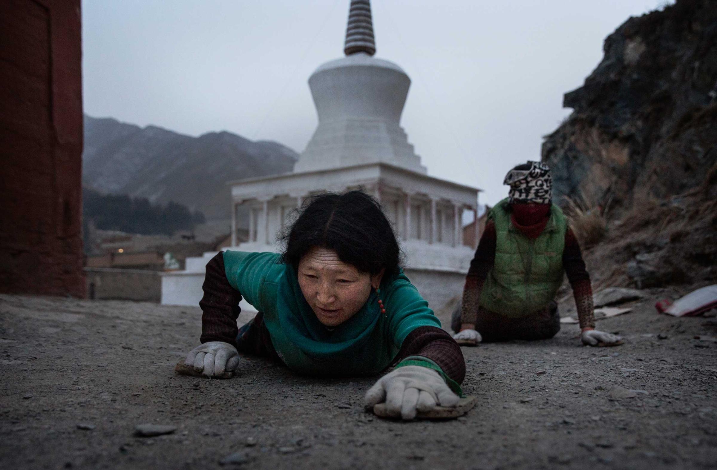 Tibetan Buddhist women prostrate during Monlam or the Great Prayer rituals at the Labrang Monastery, Xiahe County, Amdo, Tibetan Autonomous Prefecture, Gansu Province, China., March 5, 2015.