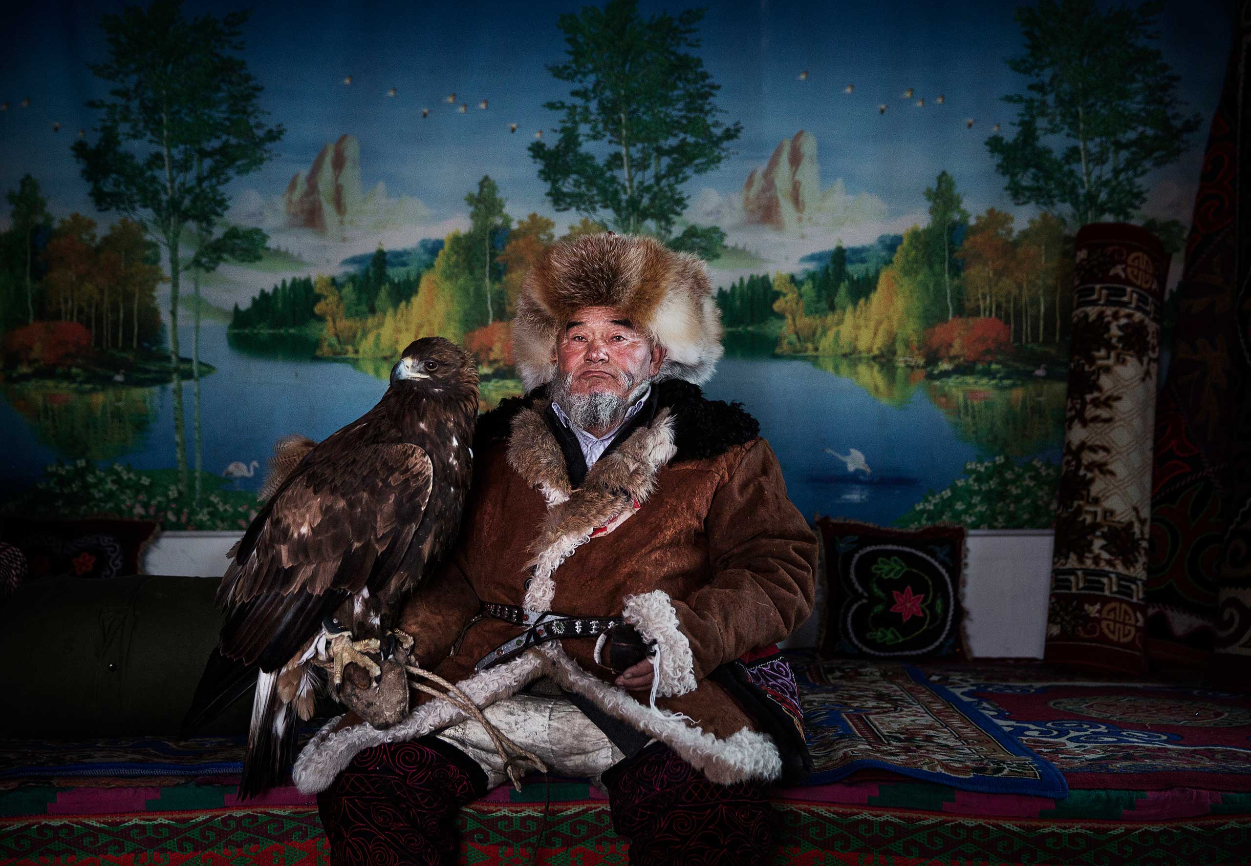 From the series: China's Kazakh Minority Preserve Culture Through Eagle Hunting in Western ChinaChinese Kazakh eagle hunter Margars Mazkin, 74 years, sits with his eagle before leaving for competition in the mountains of Qinghe County, Xinjiang, northwestern China,  Jan. 31, 2015.
