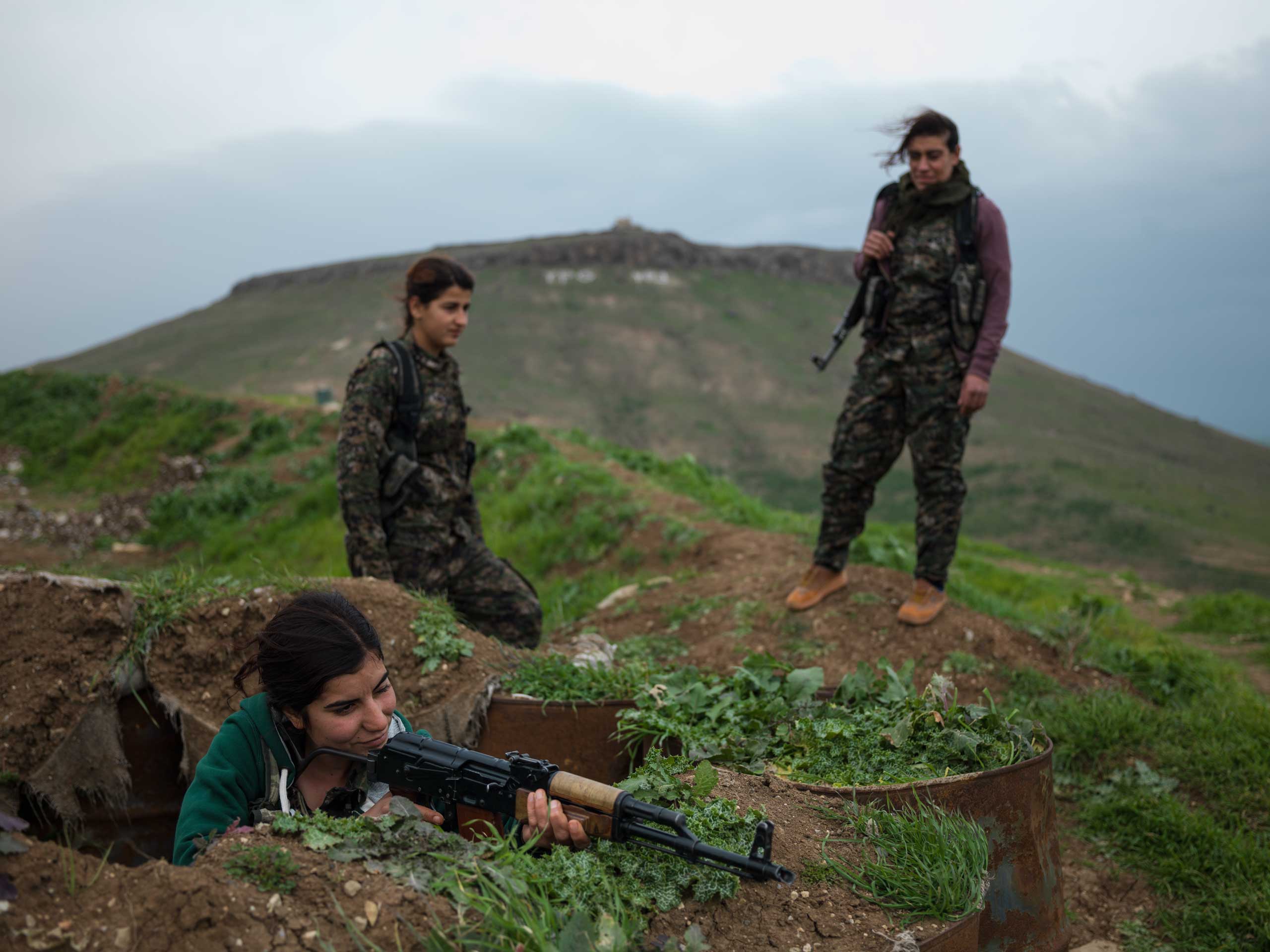YPJ fighters on their base at the border between Syria and Iraq. Young female fighters are indoctrinated to the ideology of their charismatic leader, Abdullah Ocalan, head of the Kurdish Workers' Party (PKK), who promotes marxist thought and empowerment of women.