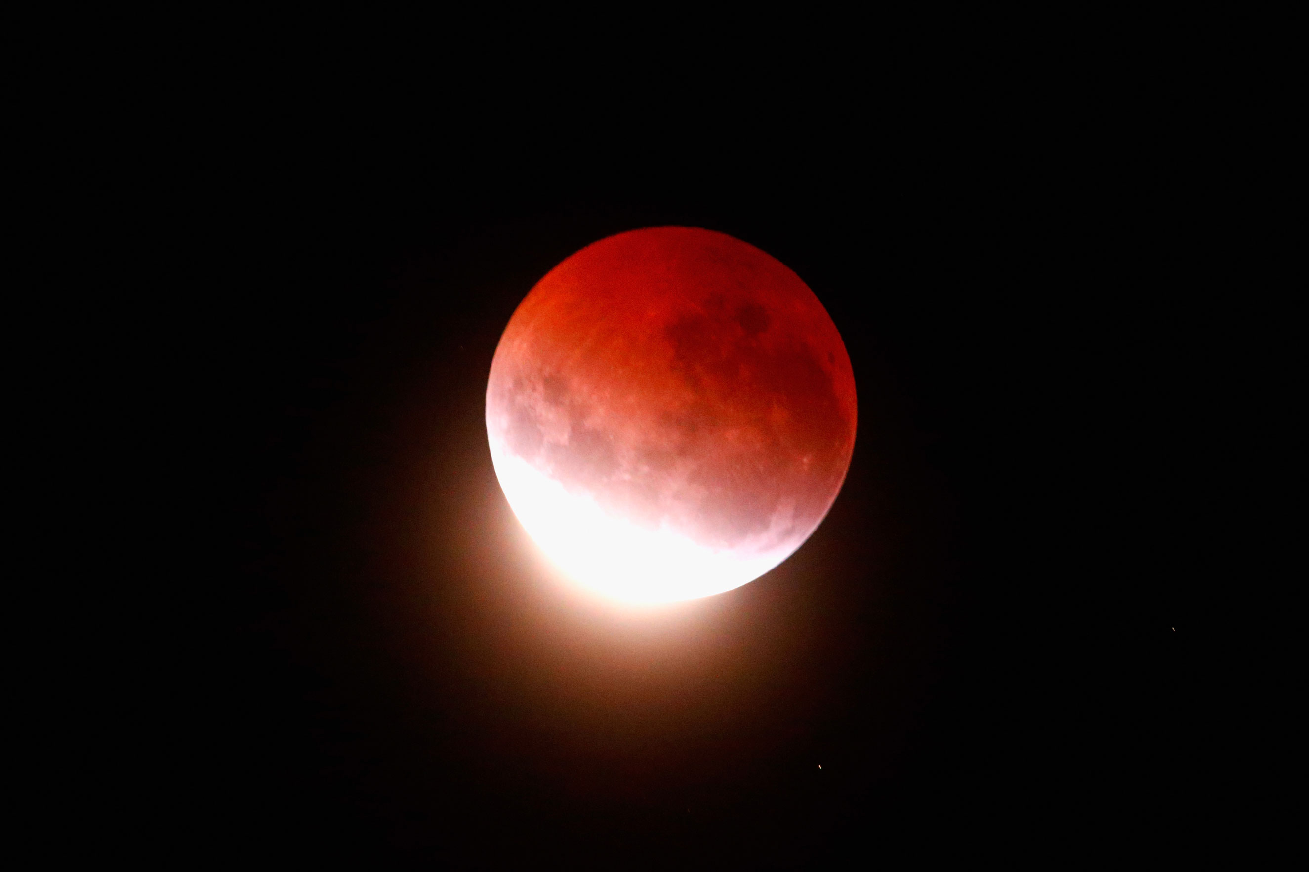 The blood moon lights up the sky during a total lunar eclipse on April 4, 2015 in Auckland.