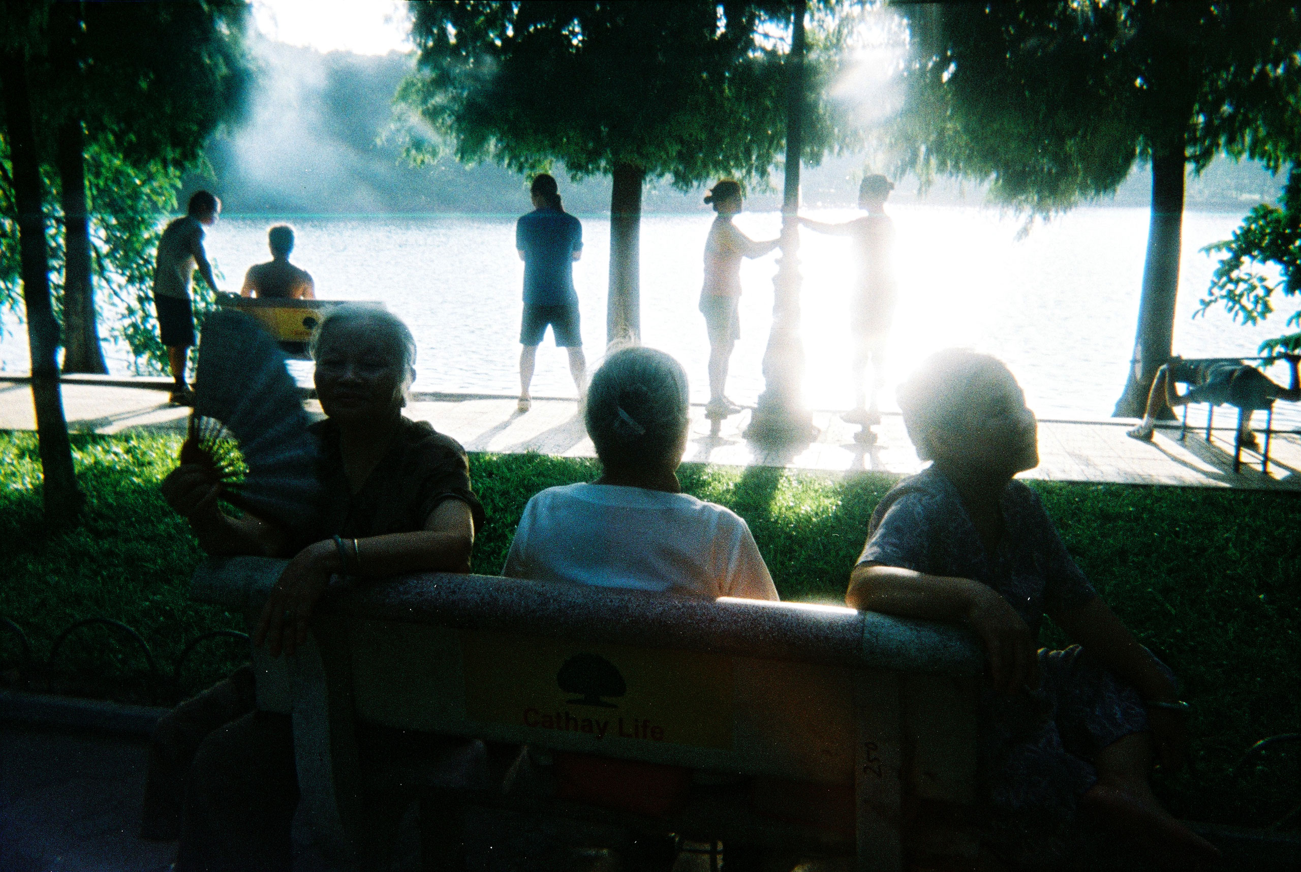 People gather to exercise in an early morning at Hoan Kiem Lake, Hanoi, August, 2011.