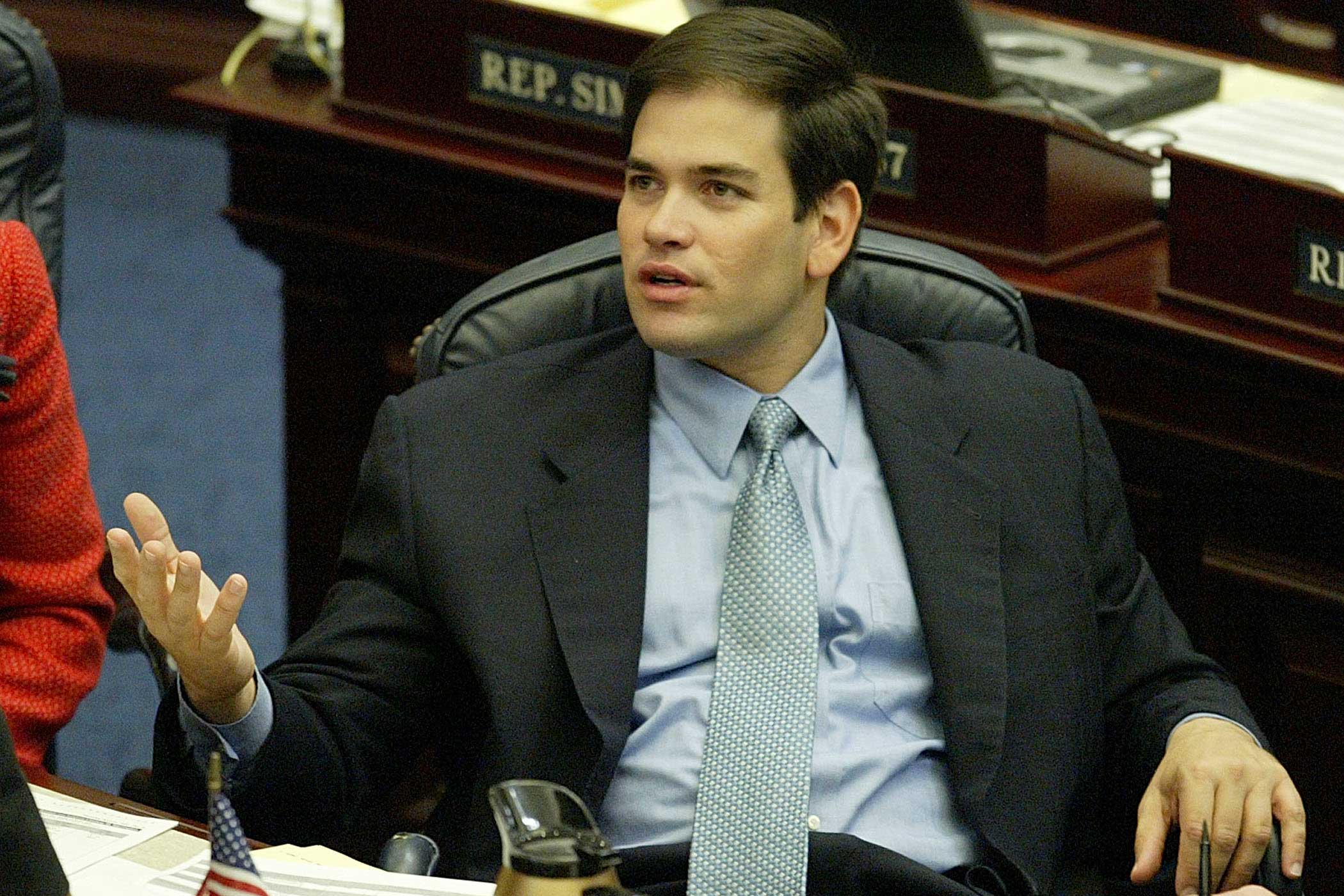 Then representative Marco Rubio talks with a colleague during House session in Tallahassee, Fla., on April 1, 2004. At age 32, Rubio was one of the youngest legislators.