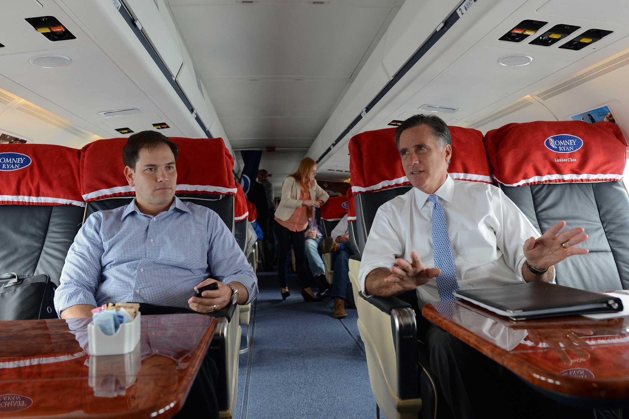Former Republican Presidential candidate Mitt Romney speaks with Senator Marco Rubio while flying from Pensacola to Orlando, Fla., on Oct. 27, 2012.