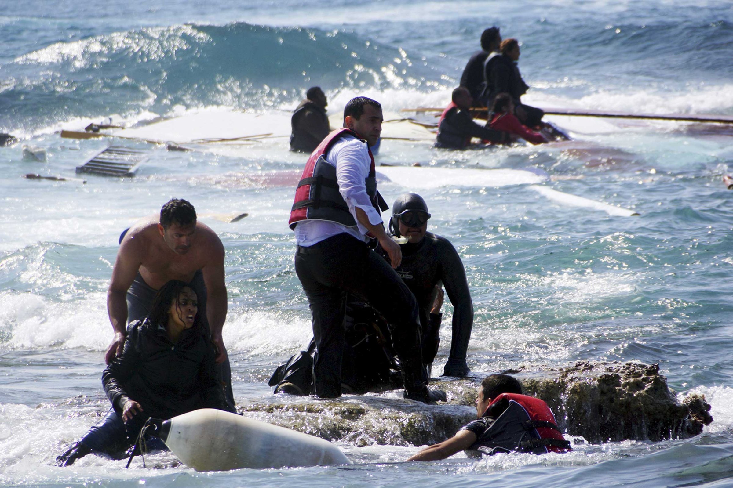 Migrants, who are trying to reach Greece, are rescued by members of the Greek Coast guard and locals near the coast of the southeastern island of Rhodes on April 20, 2015.