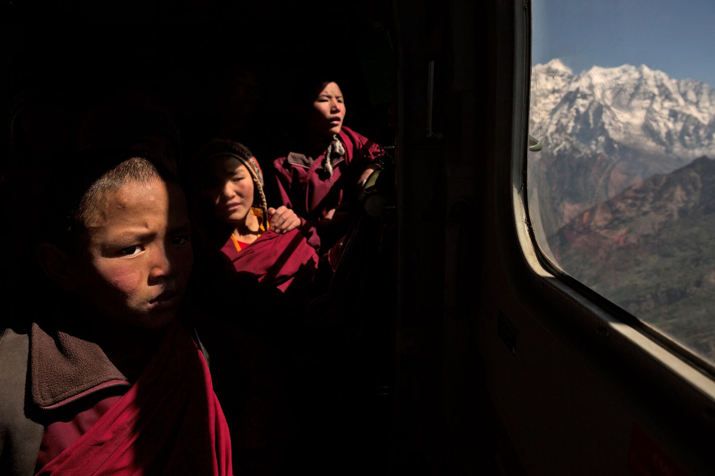 Nepal earthquake. Young Buddhist monks from Hinang Gompa (monastery) in the village of Lhi in Gorkha district in the Annapurna Range of the Himalayas were transported by Indian Army helicopter to Pokhara because the monastery was damaged in the earthquake. A boy was injured in the mountain village of Dhunchet and with his father was evacuated  by Indian Army helicopter. Mountain villages outside Pokhara that were destroyed. Food drops by Indian Army helicopters.  by James Nachtwey