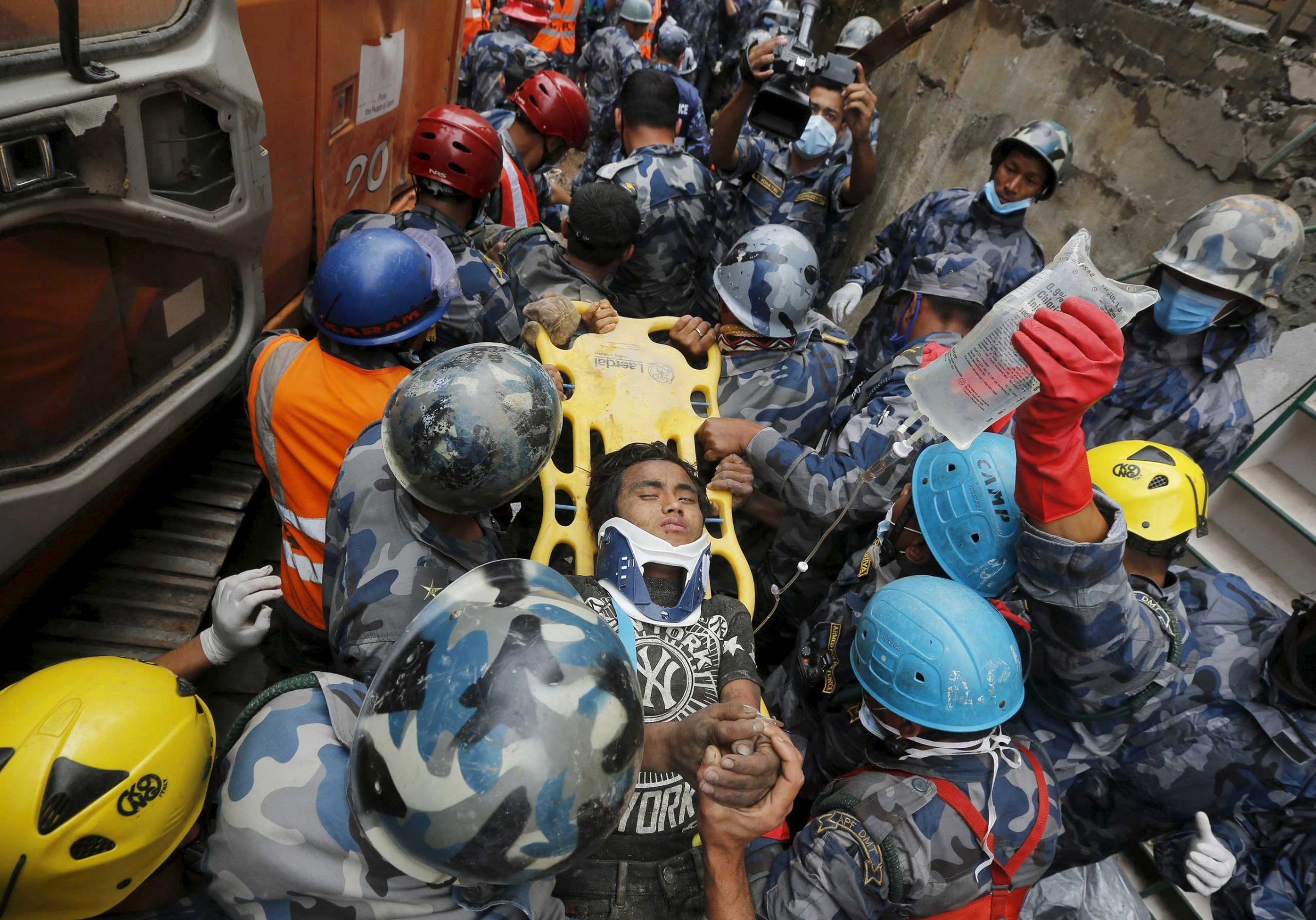 Earthquake survivor Pema Lama, 15, is rescued by the Armed Police Force from the collapsed Hilton Hotel, the result of an earthquake in Kathmandu, Nepal on April 30, 2015.