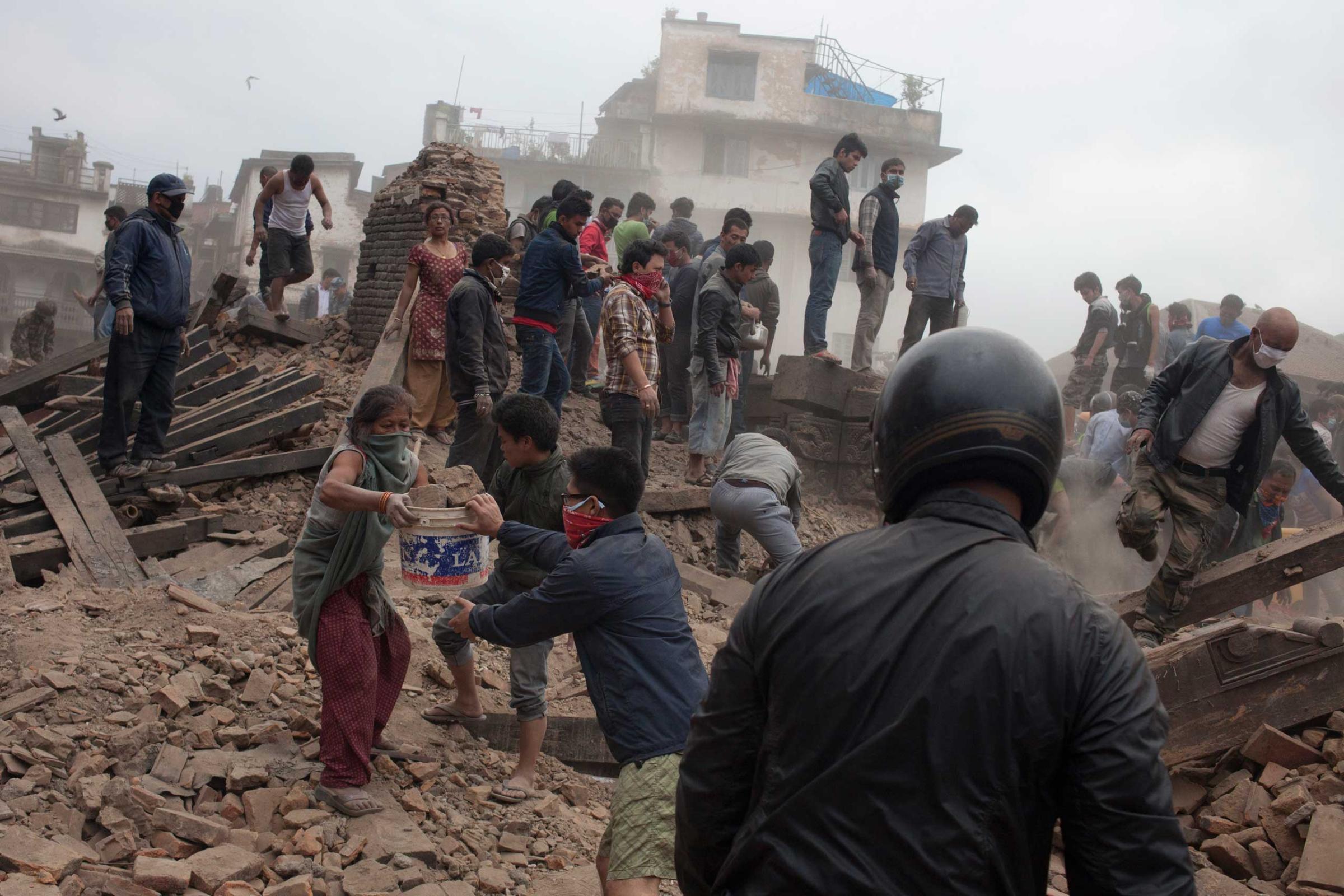 Security personnel and local people operating rescue operation at Basantapur Durbar Square in Kathmandu on April 25, 2015.