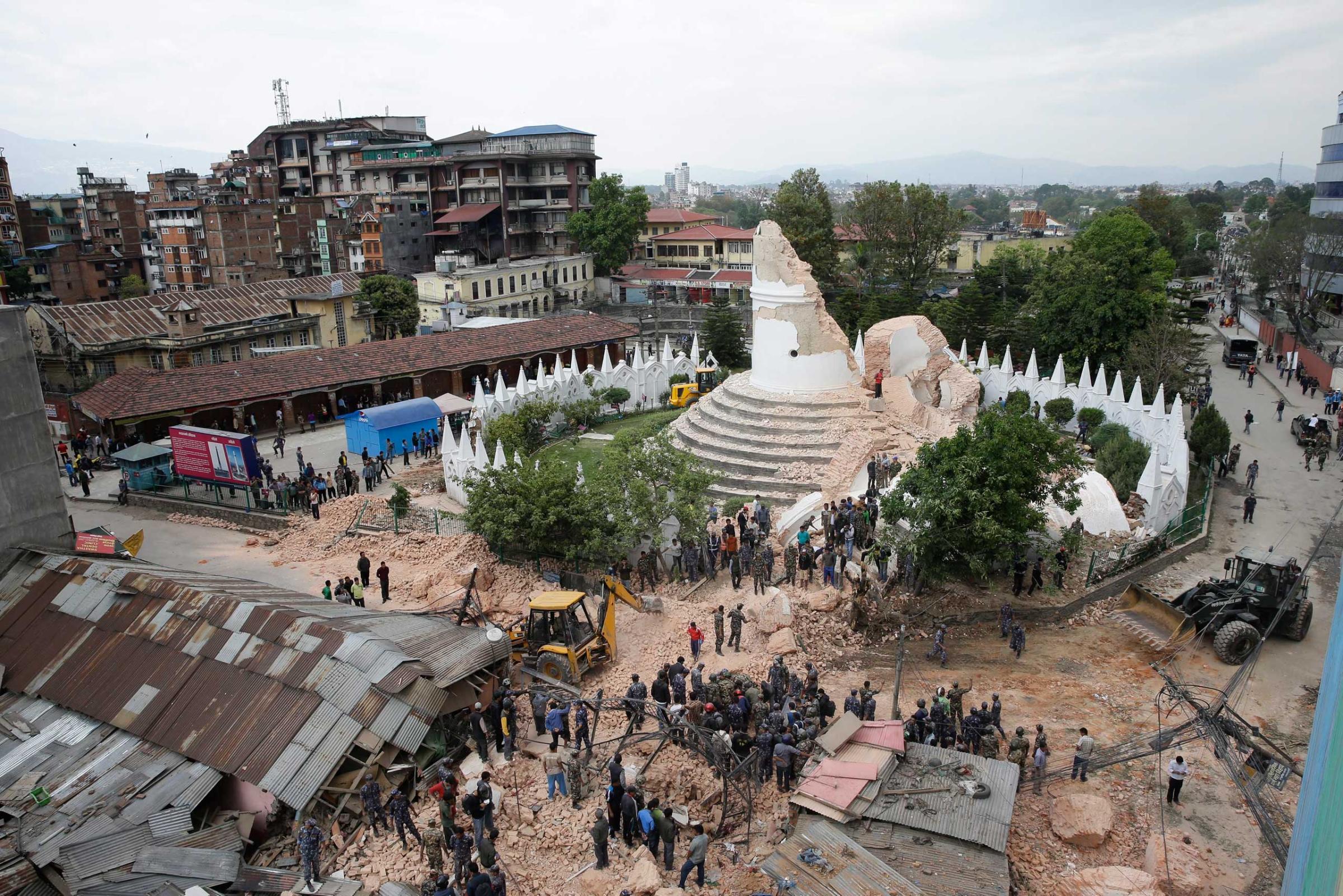 People inspect the damage of the collapsed landmark Dharahara, also called Bhimsen Tower, after the earthquake.