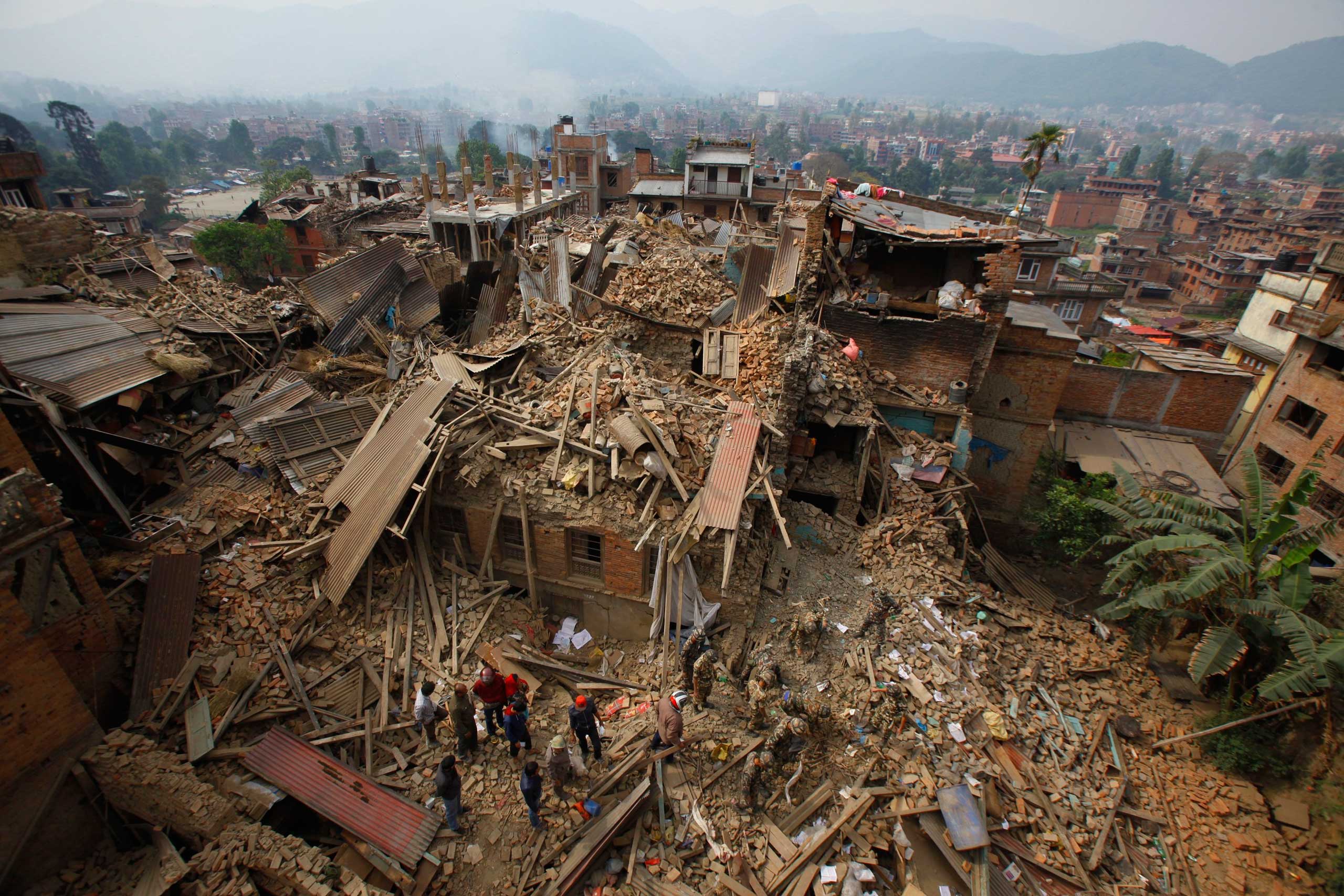 Rescue workers remove debris as they search for victims of earthquake in Bhaktapur near Kathmandu on April 26, 2015.