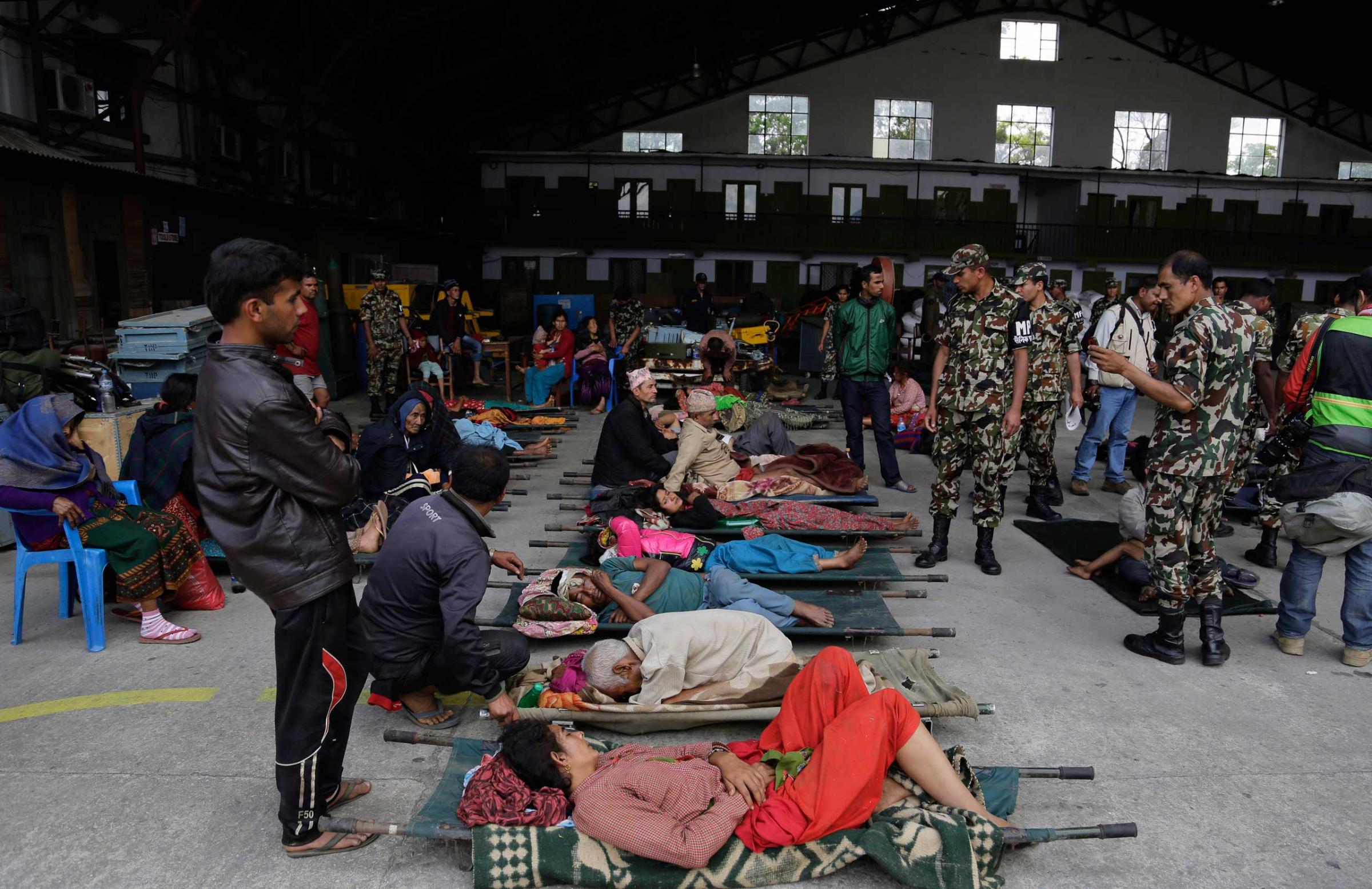 Victims of Saturday's earthquake wait for ambulances to take them to hospitals after being evacuated at the airport in Kathmandu, Nepal, on April 27, 2015.