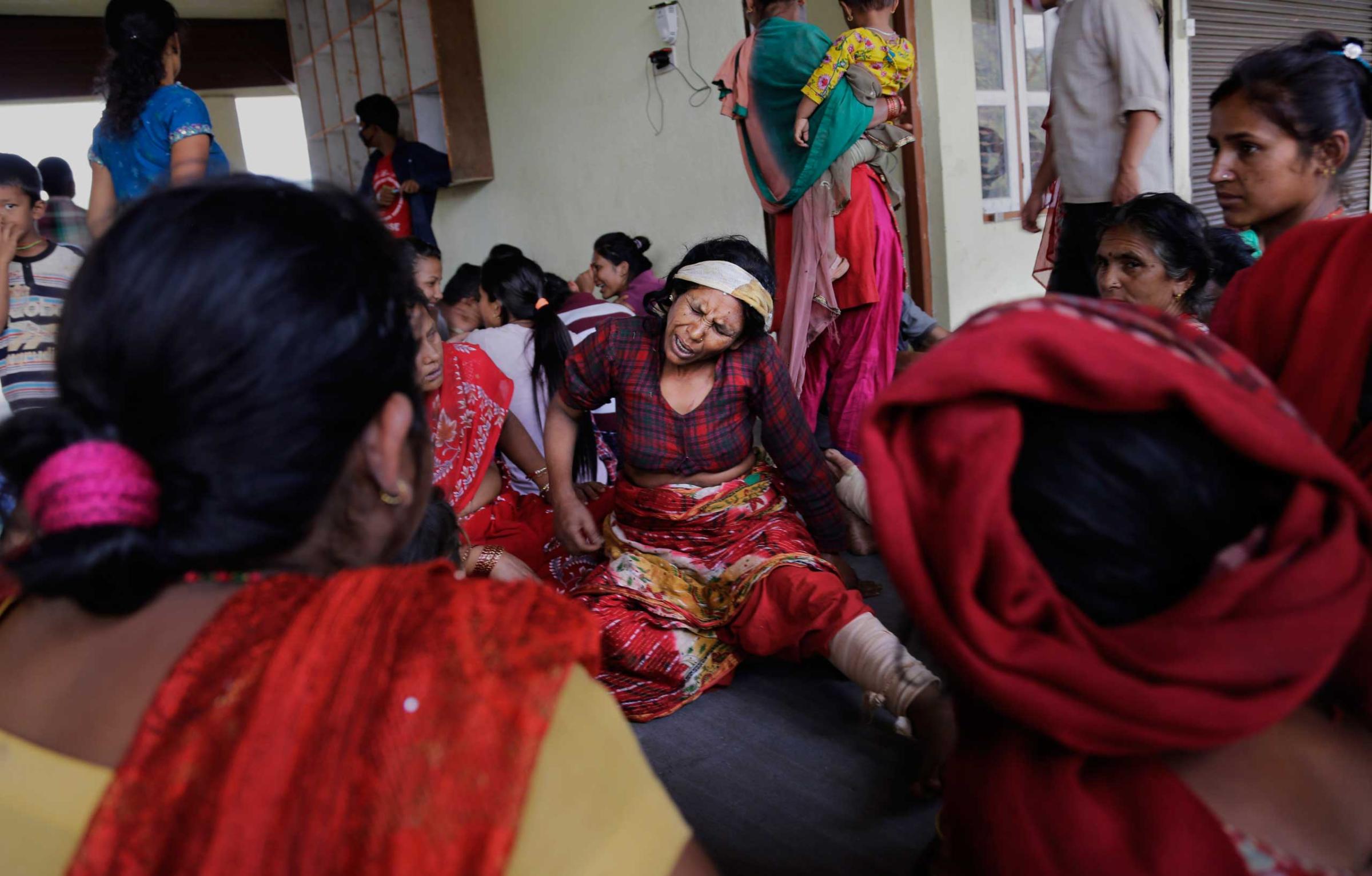 Nepalese villagers injured in Saturdayís earthquake await evacuation at Trishuli Bazar in Nepal on April 27, 2015.